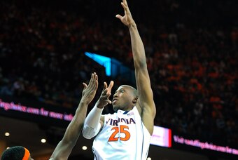 CHARLOTTESVILLE, VA - MARCH 01:  Akil Mitchell #25 of the Virginia Cavaliers takes a shot over C.J. Fair #5 of the Syracuse Orange during the first half at John Paul Jones Arena on March 1, 2014 in Charlottesville, Virginia.  (Photo by Rich Barnes/Getty I