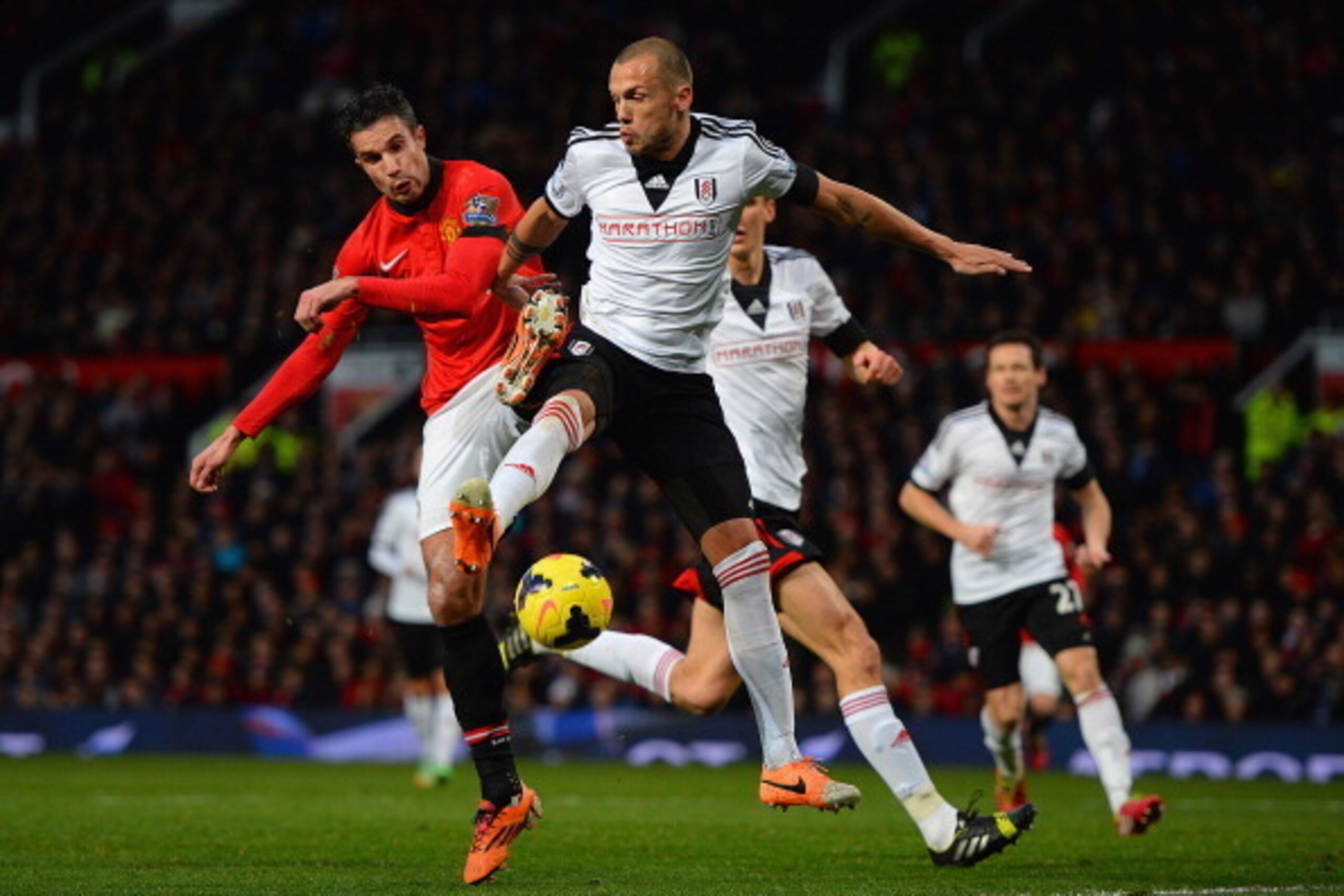 MANCHESTER, ENGLAND - FEBRUARY 09: Robin van Persie of Manchester United competes with John Heitinga of Fulham during the Barclays Premier League match between Manchester United and Fulham at Old Trafford on February 9, 2014 in Manchester, England. (Pho MANCHESTER, ENGLAND - FEBRUARY 09: Robin van Persie of Manchester United competes with John Heitinga of Fulham during the Barclays Premier League match between Manchester United and Fulham at Old Trafford on February 9, 2014 in Manchester, England. (Pho