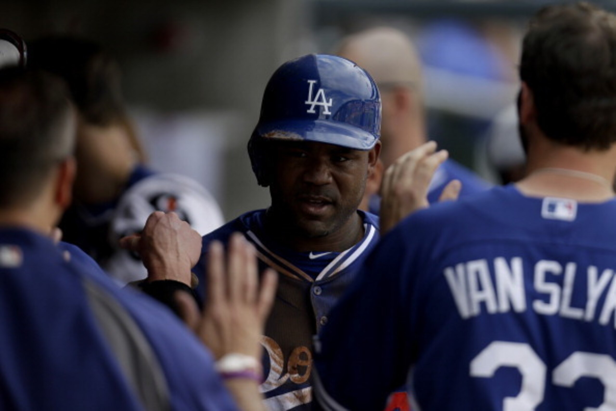 SCOTTSDALE, AZ - FEBRUARY 26: Carl Crawford #3 of the Los Angeles Dodgers celebrates in the dugout after getting hit home by Yasiel Puig during the top of the third inning against the Arizona Diamondbacks at Salt River Fields at Talking Stick on February 