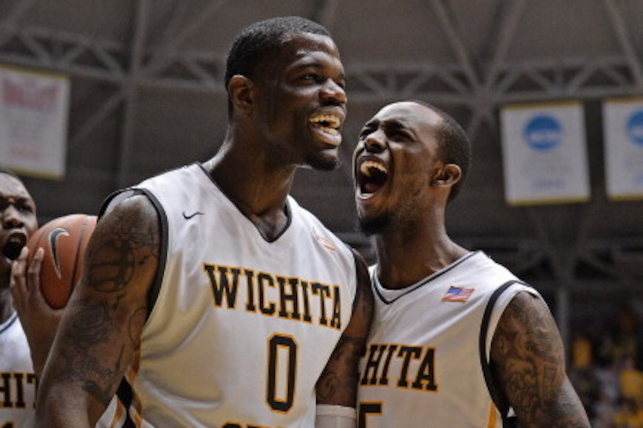 WICHITA, KS - MARCH 01:  Players Chadrack Lufile #0 and Nick Wiggins #15 of the Wichita State Shockers react after a score against the Missouri State Bears during the first half on March 1, 2014 at Charles Koch Arena in Wichita, Kansas.  (Photo by Peter A