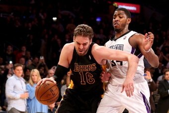 LOS ANGELES, CA - FEBRUARY 28:  Pau Gasol #16 of the Los Angeles Lakers drives past Jason Thompson #34 of the Sacramento Kings at Staples Center on February 28, 2014 in Los Angeles, California.  NOTE TO USER: User expressly acknowledges and agrees that, b