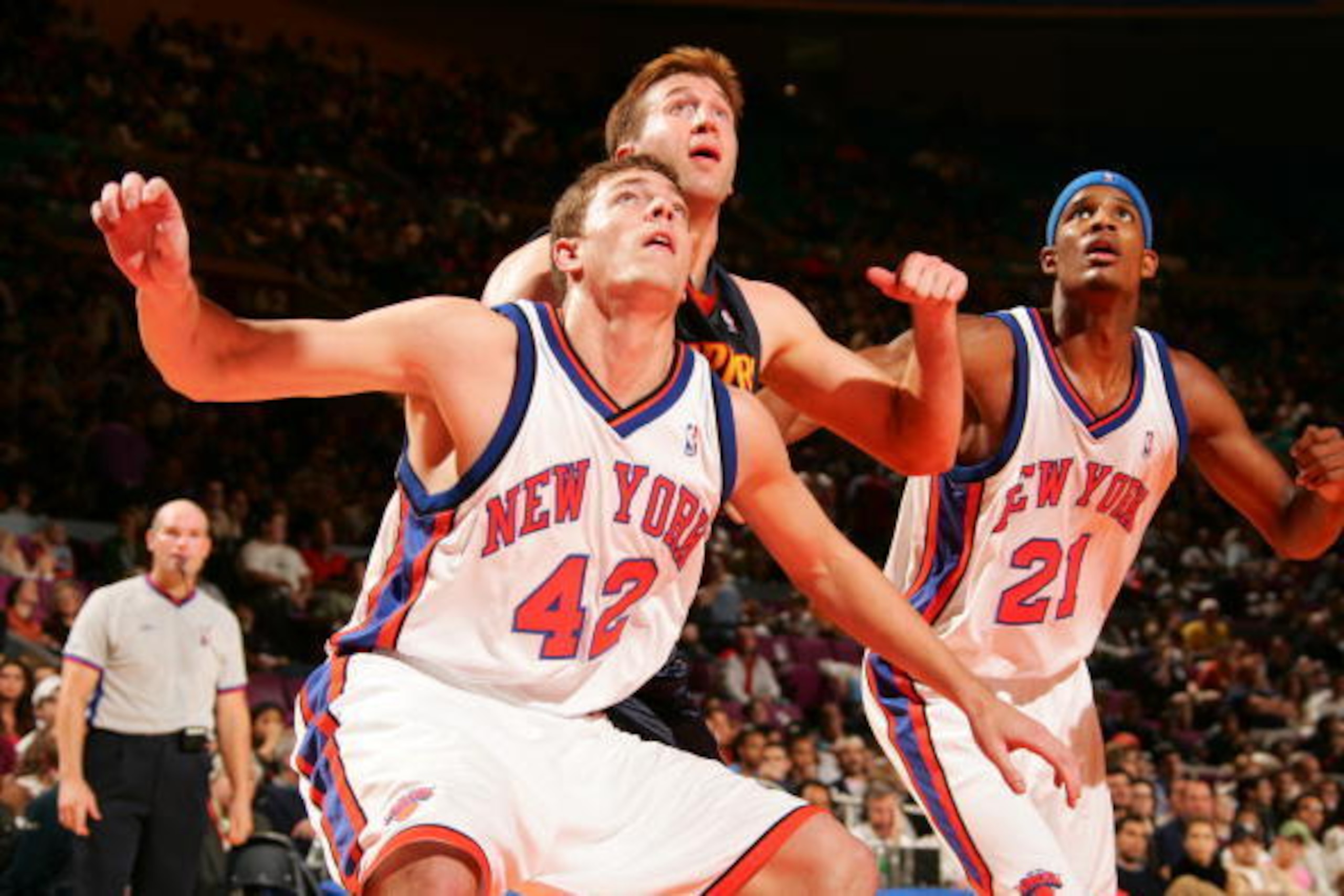 NEW YORK - NOVEMBER 6:  David Lee #42 and Trevor Ariza #21 of the New York Knicks fight for rebound position against Troy Murphy #1 of the Golden State Warriors November 6, 2005 at Madison Square Garden in New York City, New York. The Warriors won 83-81. 