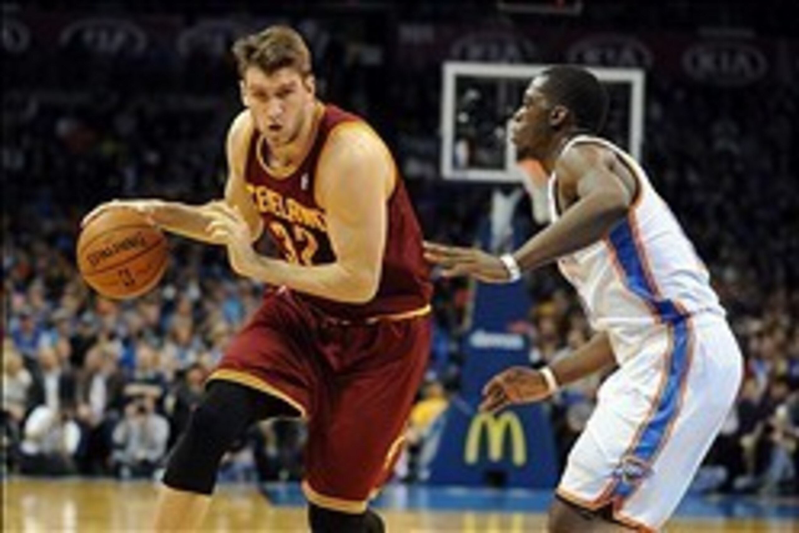 Feb 26, 2014; Oklahoma City, OK, USA; Cleveland Cavaliers center Spencer Hawes (32) handles the ball against Oklahoma City Thunder point guard Reggie Jackson (15) during the second quarter at Chesapeake Energy Arena. Mandatory Credit: Mark D. Smith-USA TO