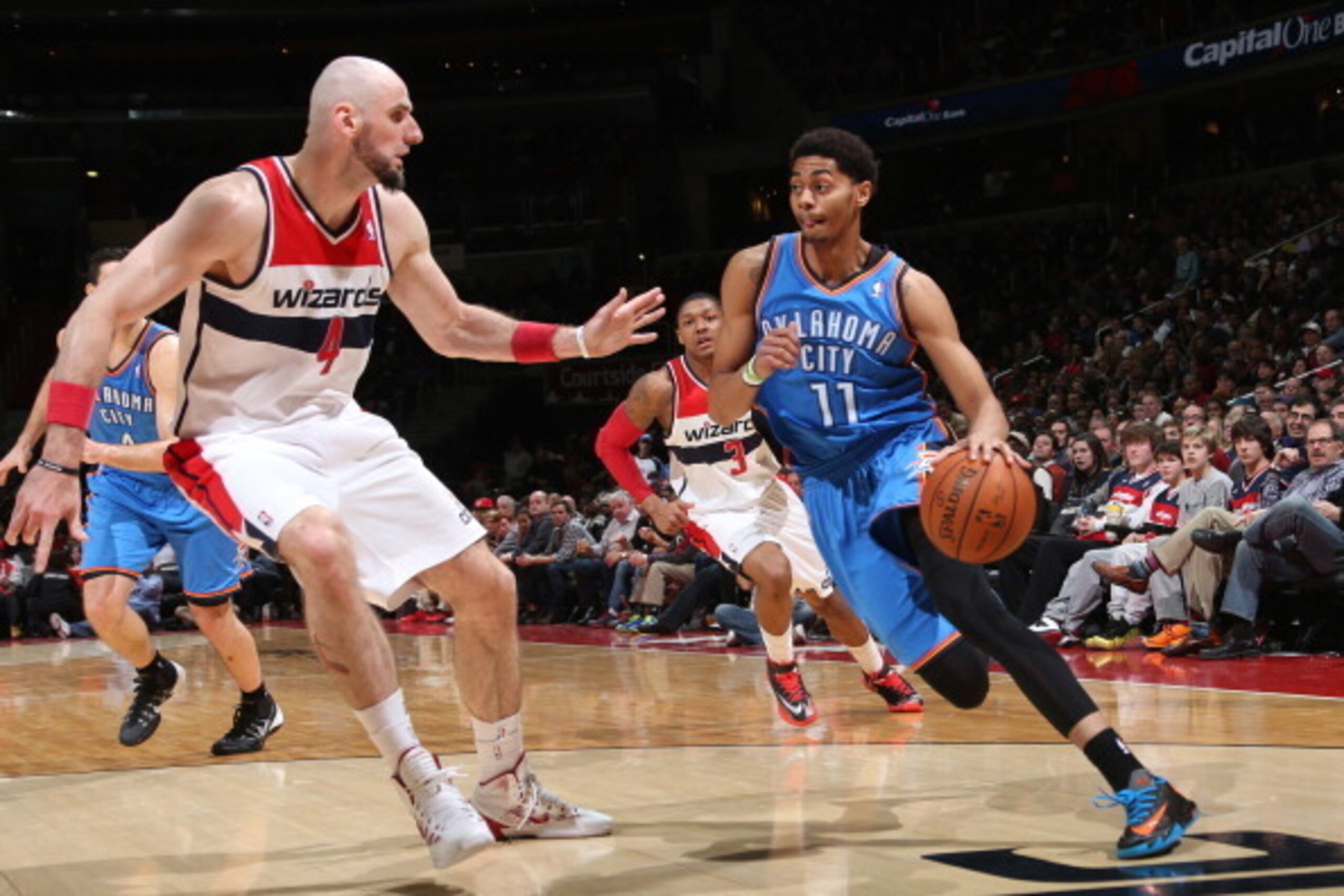 WASHINGTON, DC - FEBRUARY 2: Jeremy Lamb #11 of the Oklahoma City Thunder drives against Marcin Gortat #4 of the Washington Wizards at the Verizon Center on February 2, 2014 in Washington, DC. NOTE TO USER: User expressly acknowledges and agrees that, by 