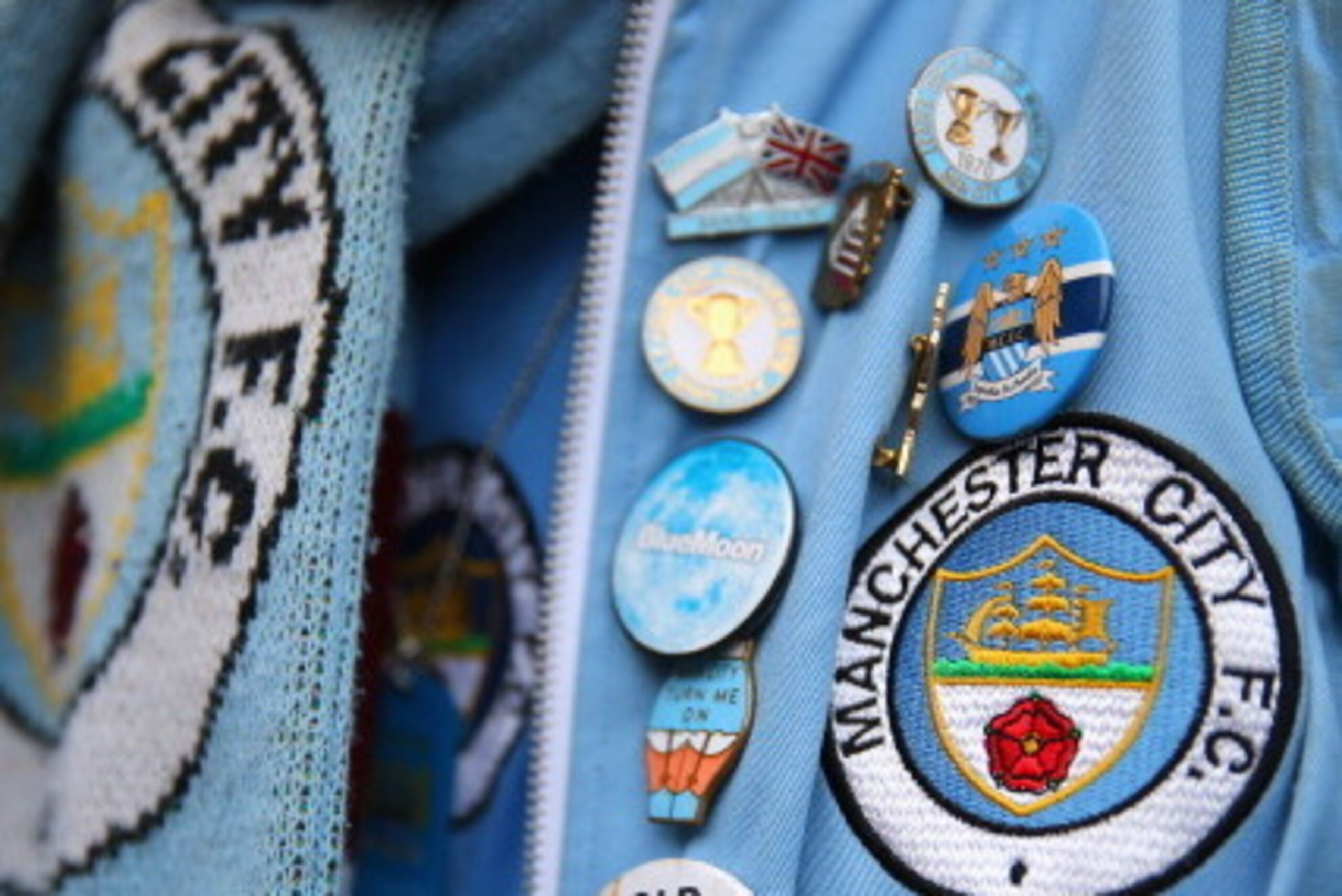 LONDON, ENGLAND - OCTOBER 27:  A Man City supporter shows off his pin badges ahead of the Barclays Premier League match between Chelsea and Manchester City at Stamford Bridge on October 27, 2013 in London, England.  (Photo by Clive Rose/Getty Images)