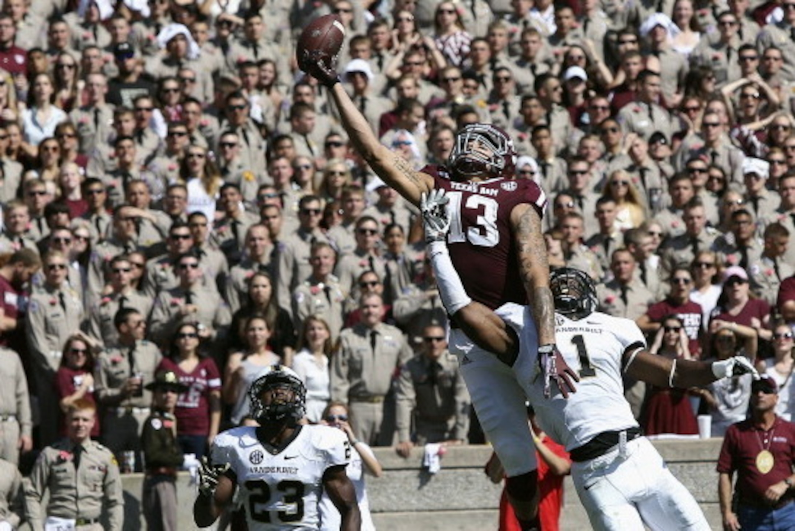 COLLEGE STATION, TX - OCTOBER 26:  Mike Evans #13 of the Texas A&M Aggies has the ball go off his fingertips as he goes up between Kenny Ladler #1 of the Vanderbilt Commodores and Andre Hal #23 of the Vanderbilt Commodores in the second quarter at Kyle Fi
