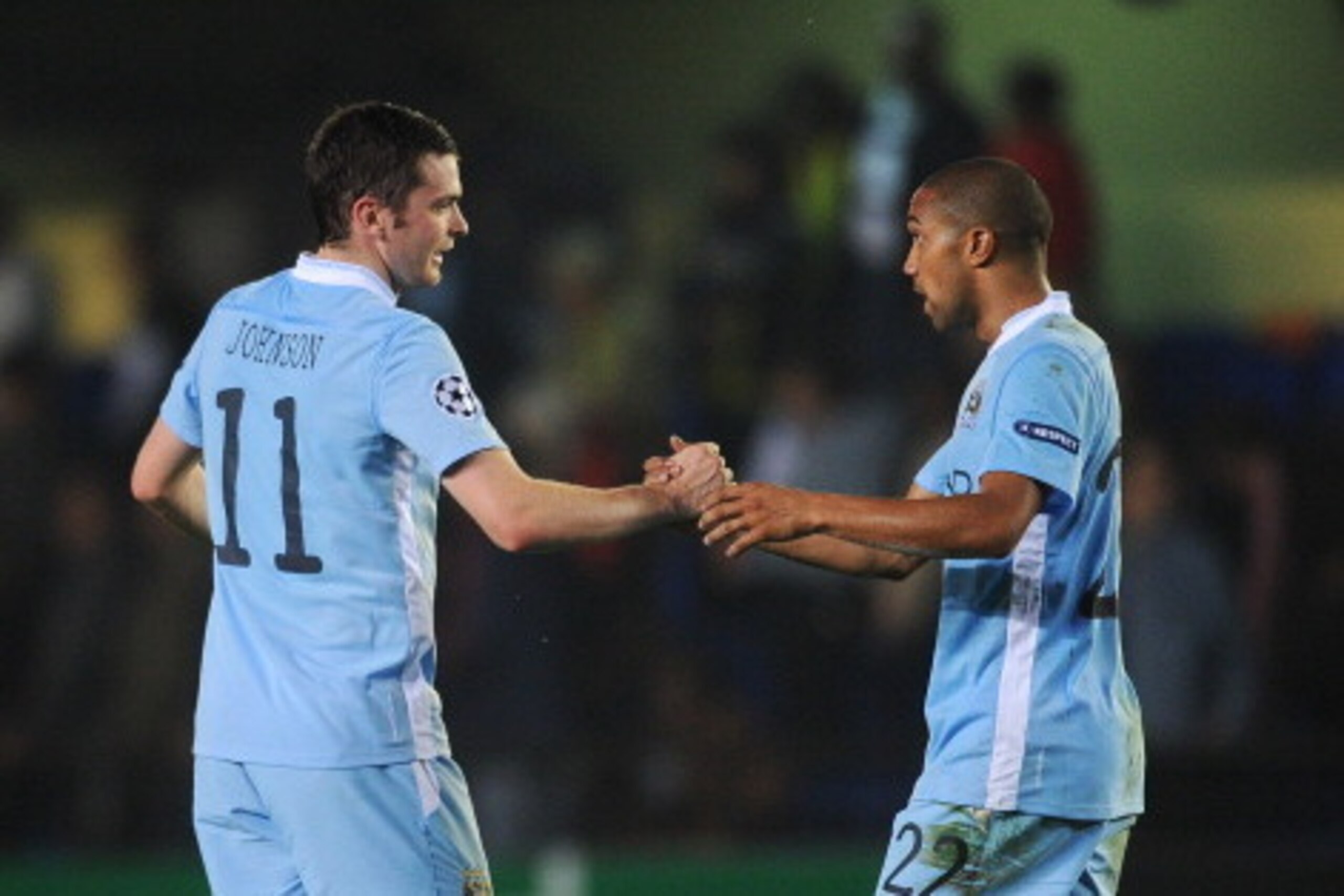 VILLARREAL, SPAIN - NOVEMBER 02: Adam Johnson (L) greets Gael Clichy of Manchester City FC at the end of the UEFA Champions League group A match between Villarreal CF and Manchester City FC at the El Madrigal stadium on November 2, 2011 in Villarreal, Spa