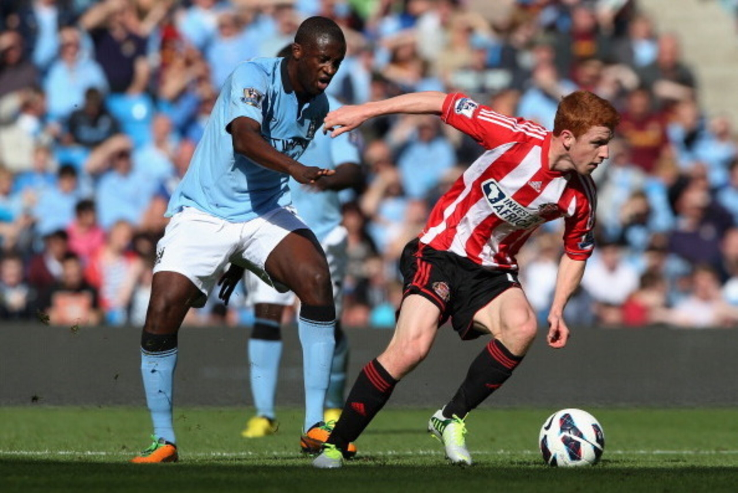 MANCHESTER, ENGLAND - OCTOBER 06:  Jack Colback of Sunderland competes with Yaya Toure of Manchester City during the Barclays Premier League match between Manchester City and Sunderland at the Etihad Stadium on October 6, 2012 in Manchester, England.  (Ph