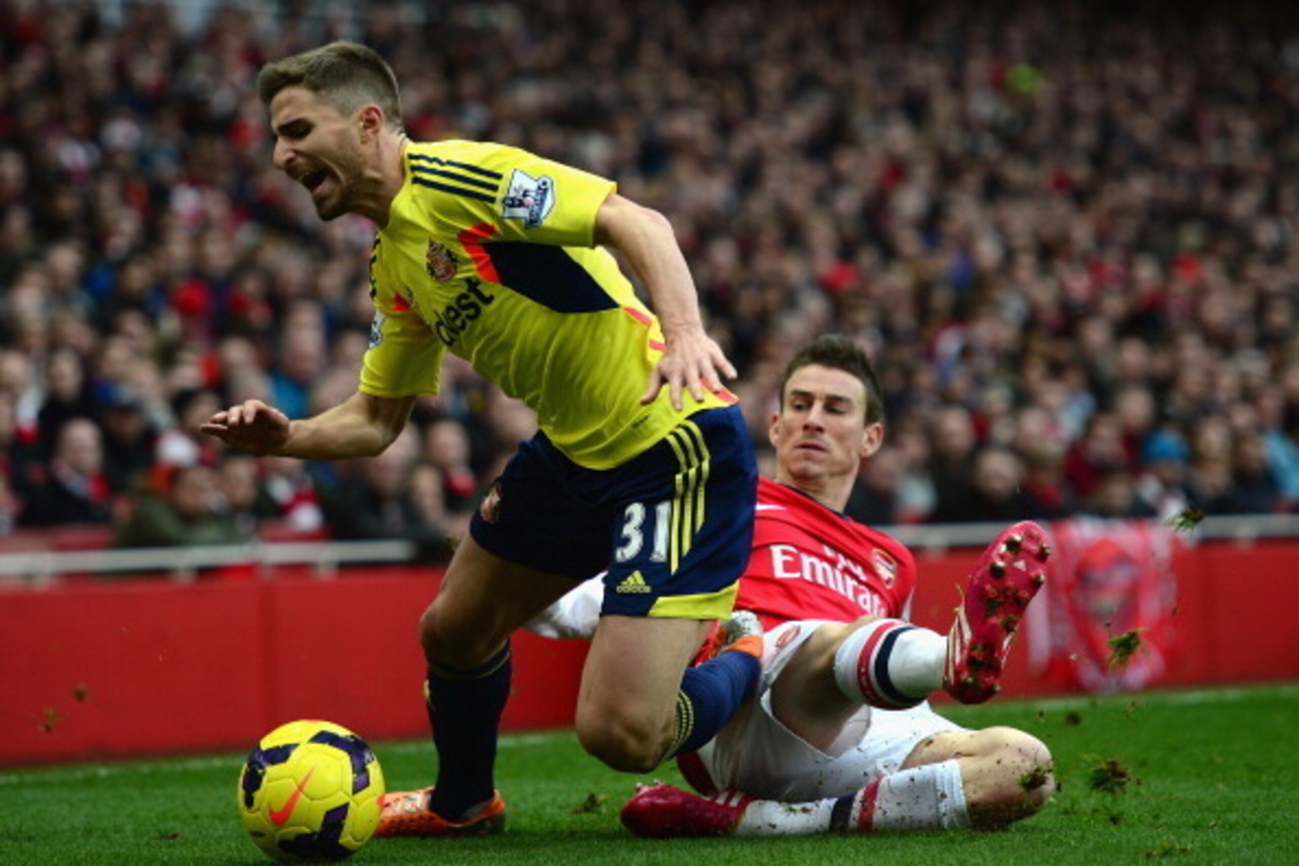 LONDON, ENGLAND - FEBRUARY 22:  Fabio Borini of Sunderland is tackled by Laurent Koscielny of Arsenal during the Barclays Premier League match between Arsenal and Sunderland at Emirates Stadium on February 22, 2014 in London, England.  (Photo by Jamie McD