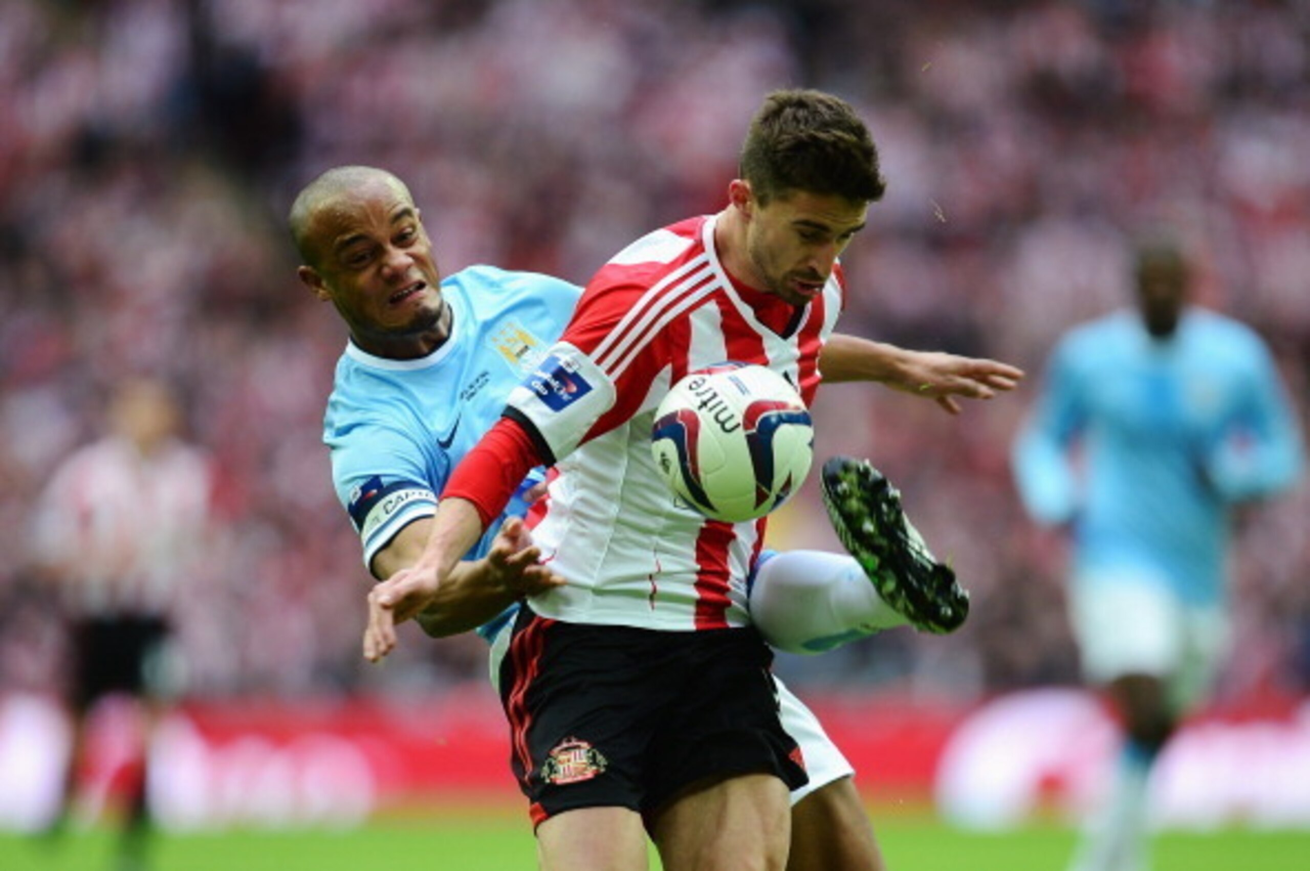 LONDON, ENGLAND - MARCH 02: Vincent Kompany of Manchester City tackles Fabio Borini of Sunderland during the Capital One Cup Final between Manchester City and Sunderland at Wembley Stadium on March 2, 2014 in London, England. (Photo by Jamie McDonald/Ge LONDON, ENGLAND - MARCH 02: Vincent Kompany of Manchester City tackles Fabio Borini of Sunderland during the Capital One Cup Final between Manchester City and Sunderland at Wembley Stadium on March 2, 2014 in London, England. (Photo by Jamie McDonald/Ge