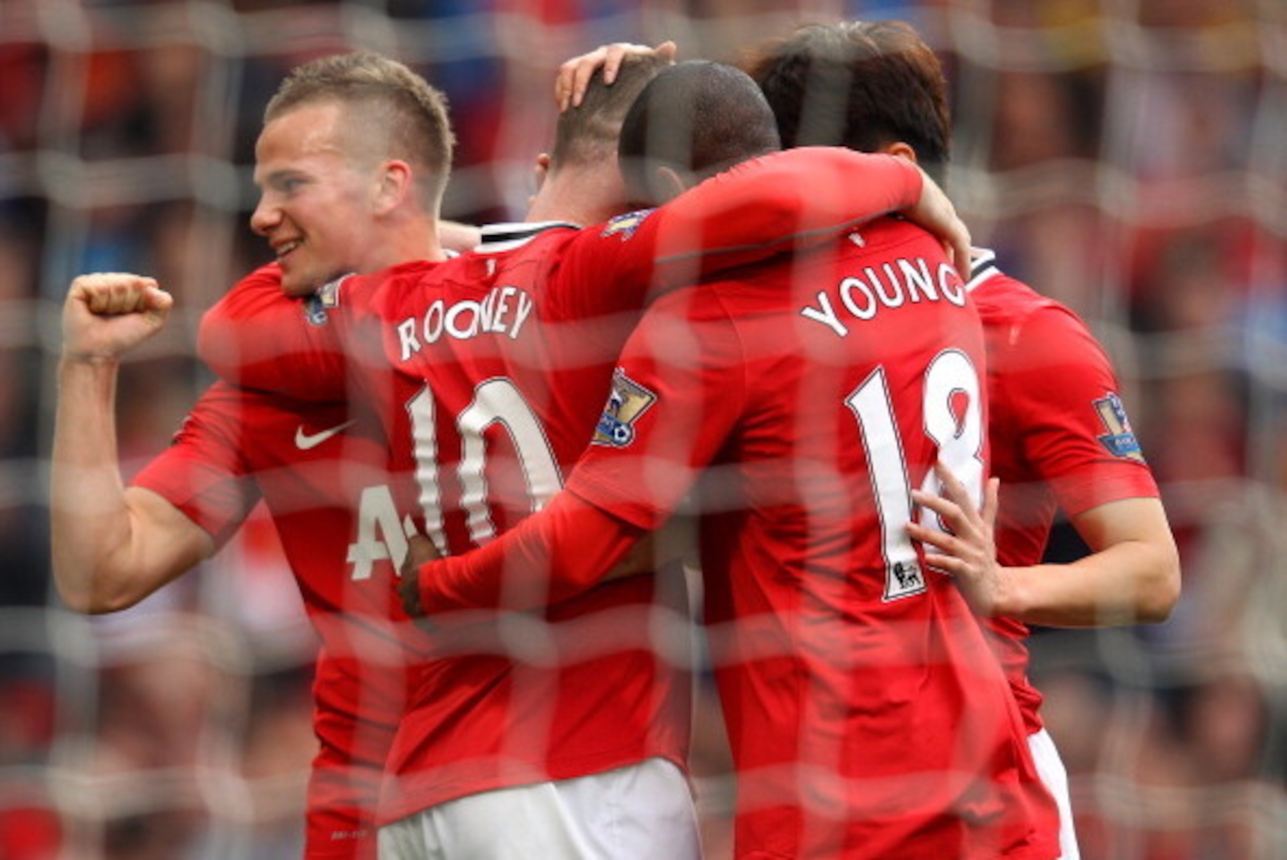 MANCHESTER, ENGLAND - AUGUST 28:  Wayne Rooney of Manchester United celebrates Tom Cleverley and Ashley Young after scoring his third goal from the penalty spot during the Barclays Premier League match between Manchester United and Arsenal at Old Trafford