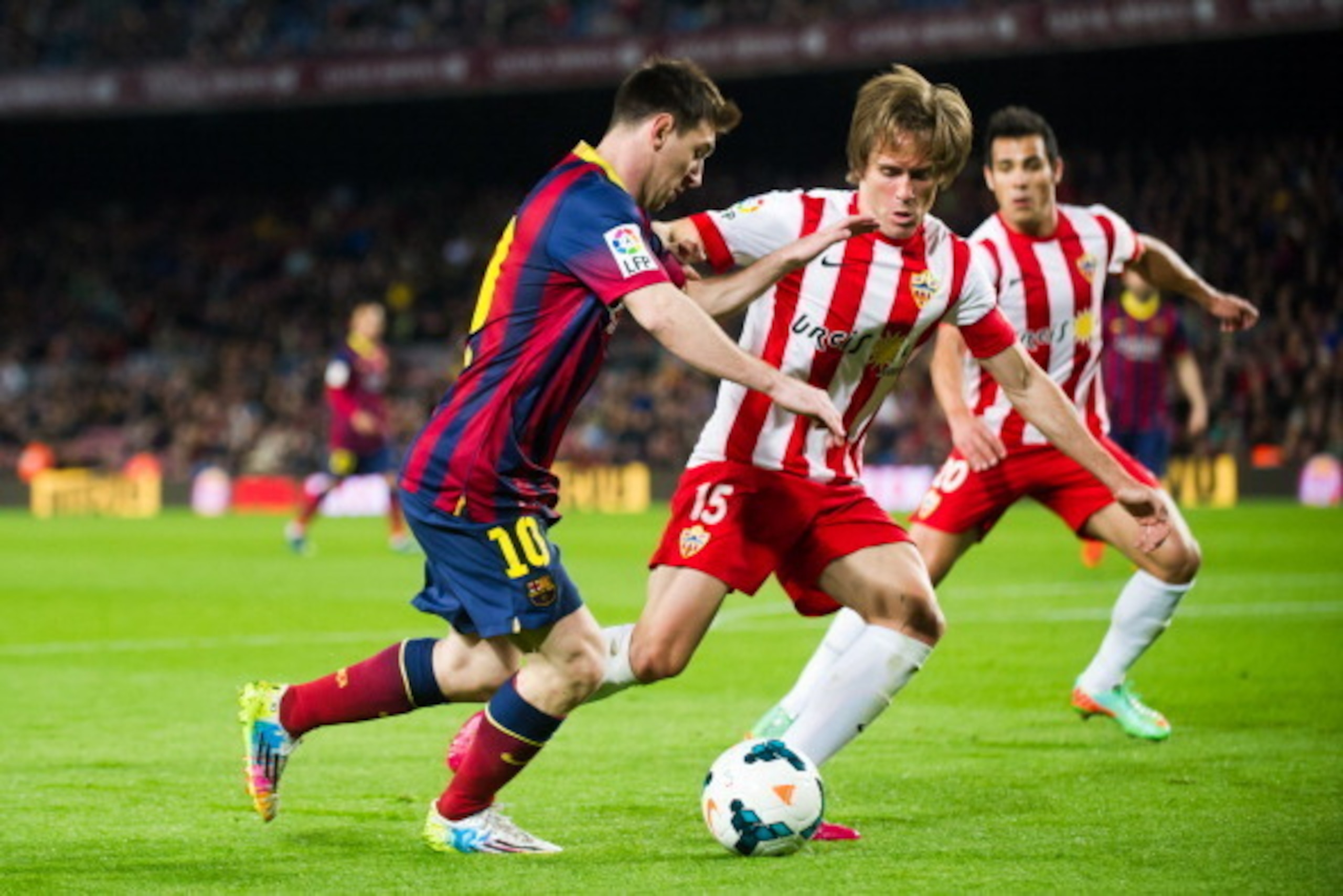 BARCELONA, SPAIN - MARCH 02: Leo Messi of FC Barcelona duels for the ball with Miguel Angel Garcia 'Corona' of UD Almeria during the La Liga match between FC Barcelona and UD Almeria at Camp Nou on March 2, 2014 in Barcelona, Spain.  (Photo by Alex Caparr