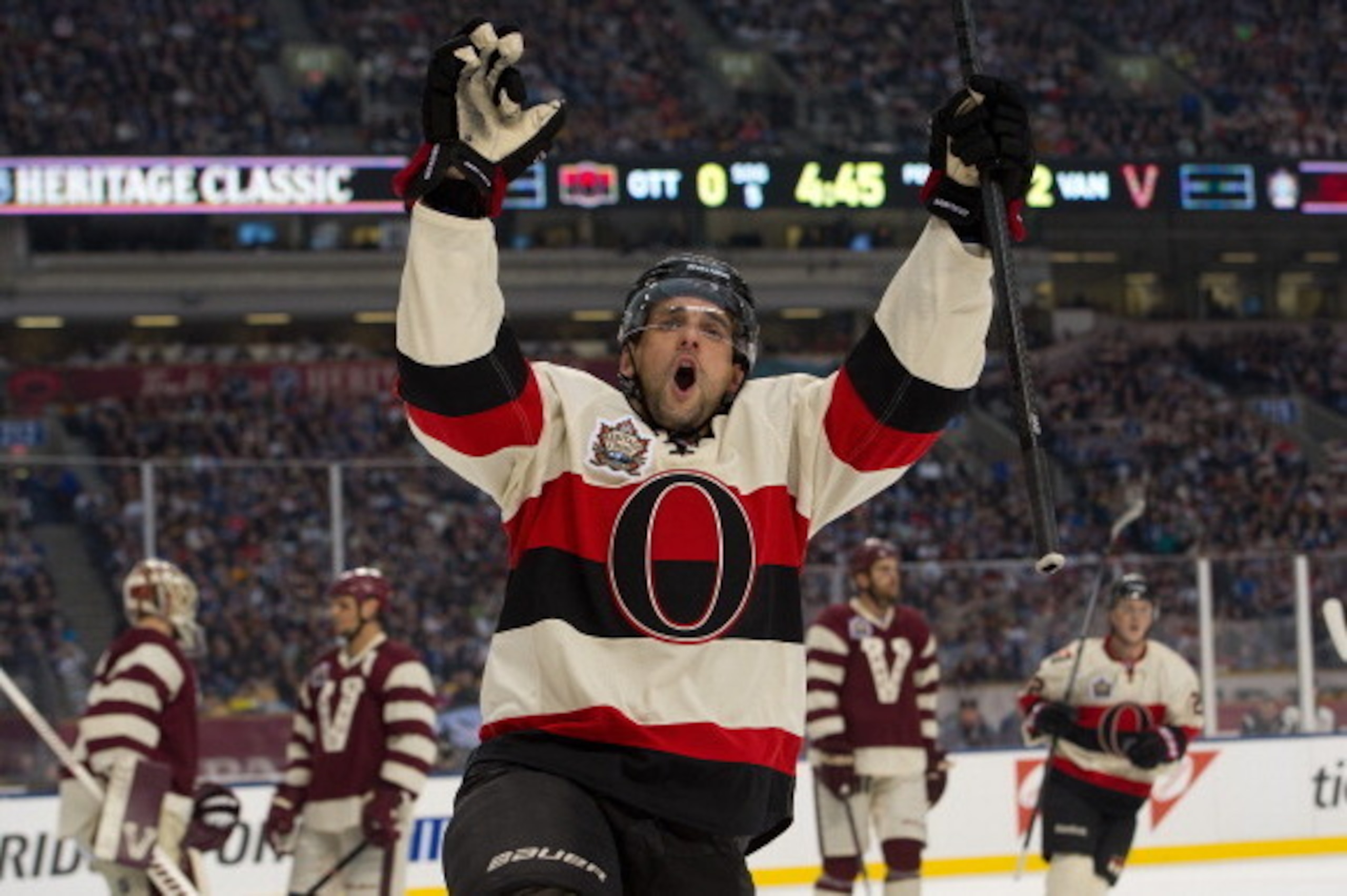 VANCOUVER, BC - MARCH 2: (EDITORIAL USE ONLY) Clarke MacArthur #16 of the Ottawa Senators celebrates after scoring a goal during the first period in NHL action against the Vancouver Canucks on March 02, 2014 during the 2014 Tim Hortons Heritage Classic at