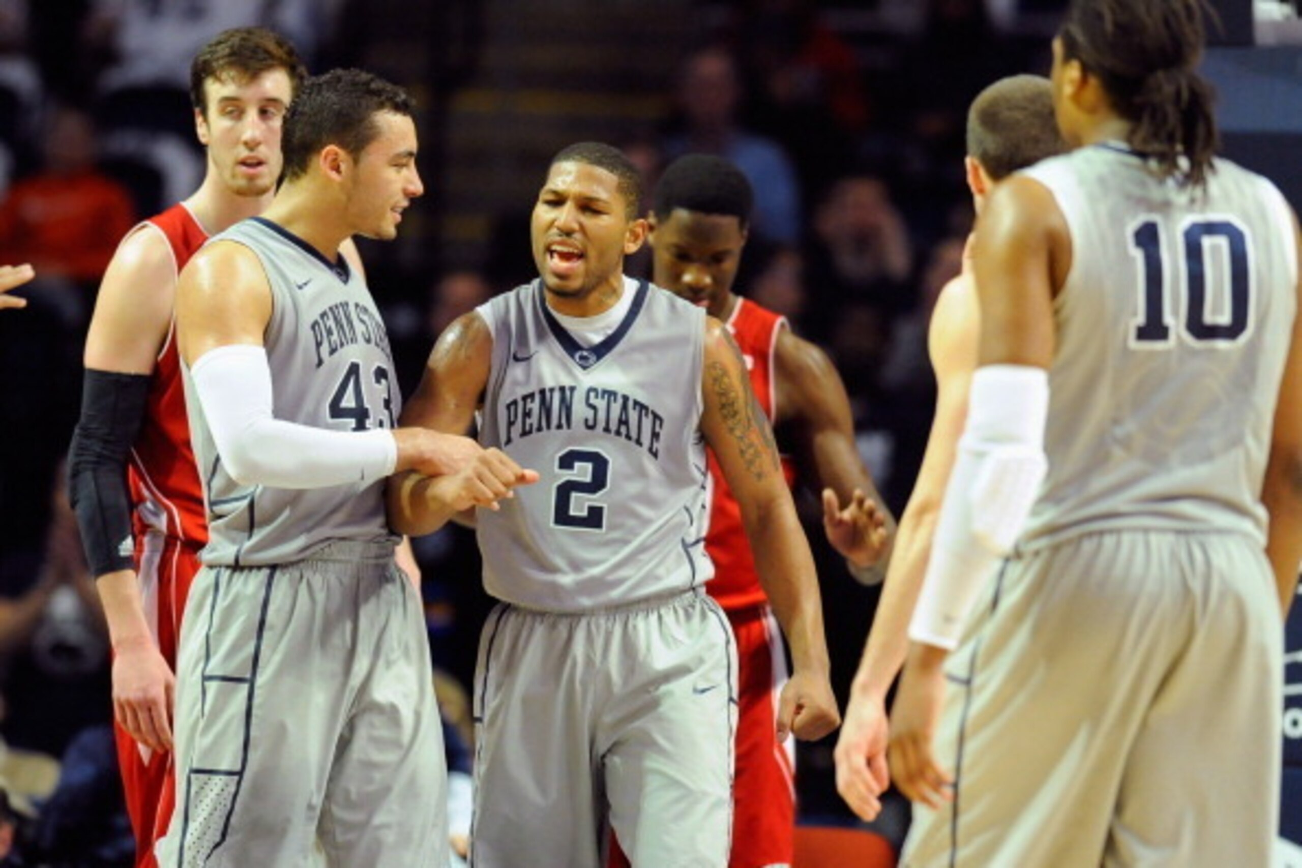 UNIVERSITY PARK, PA - MARCH 02:  D.J. Newbill #2 of the Penn State Nittany Lions reacts with teammate Ross Travis #43 after a made basket and foul call against the Wisconsin Badgers during the second half at the Bryce Jordan Center on March 2, 2014 in Uni