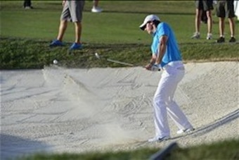 Mar 2, 2014; Palm Beach Gardens, FL, USA; Rory McIlroy hits out of the trap to the 17th green during the final round of The Honda Classic golf tournament at PGA National GC Champion Course. Mandatory Credit: Bob Donnan-USA TODAY Sports