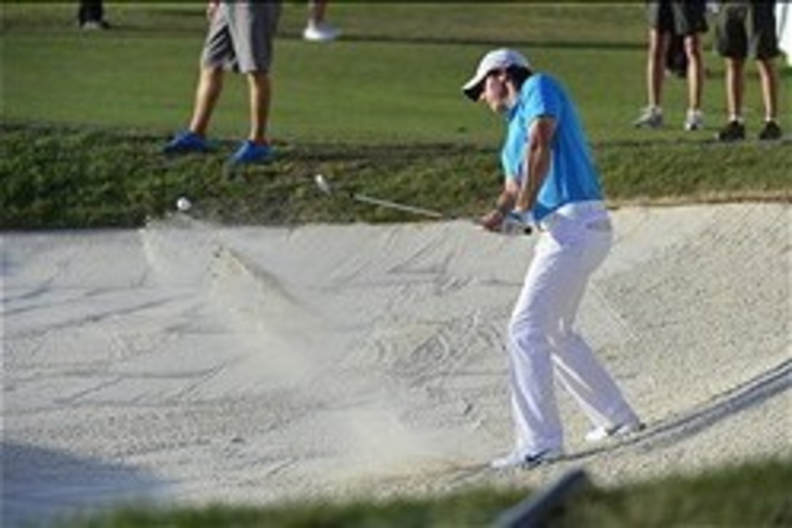Mar 2, 2014; Palm Beach Gardens, FL, USA; Rory McIlroy hits out of the trap to the 17th green during the final round of The Honda Classic golf tournament at PGA National GC Champion Course. Mandatory Credit: Bob Donnan-USA TODAY Sports