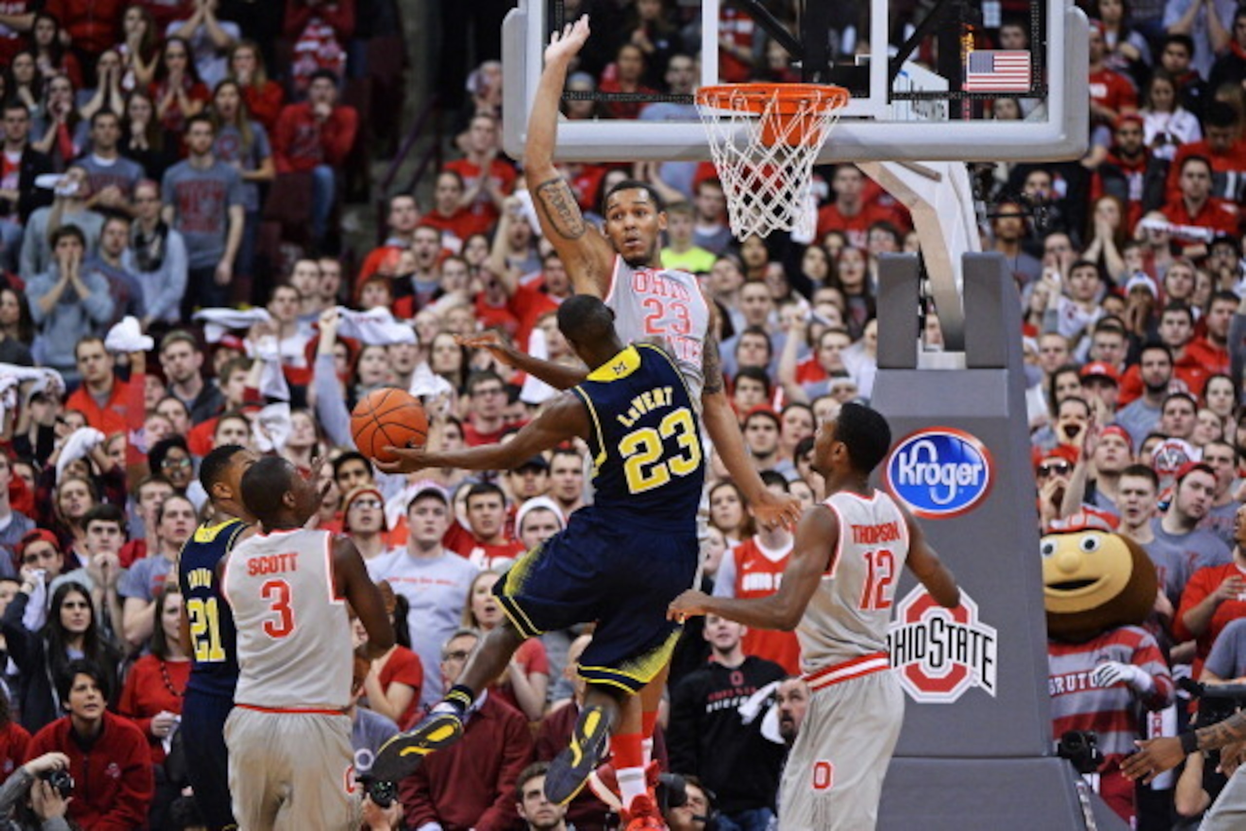 COLUMBUS, OH - FEBRUARY 11:  Amir Williams #23 of the Ohio State Buckeyes defends as Caris LeVert #23 of the Michigan Wolverines attempts to drive to the basket in the second half on February 11, 2014 at Value City Arena in Columbus, Ohio. Michigan defeat