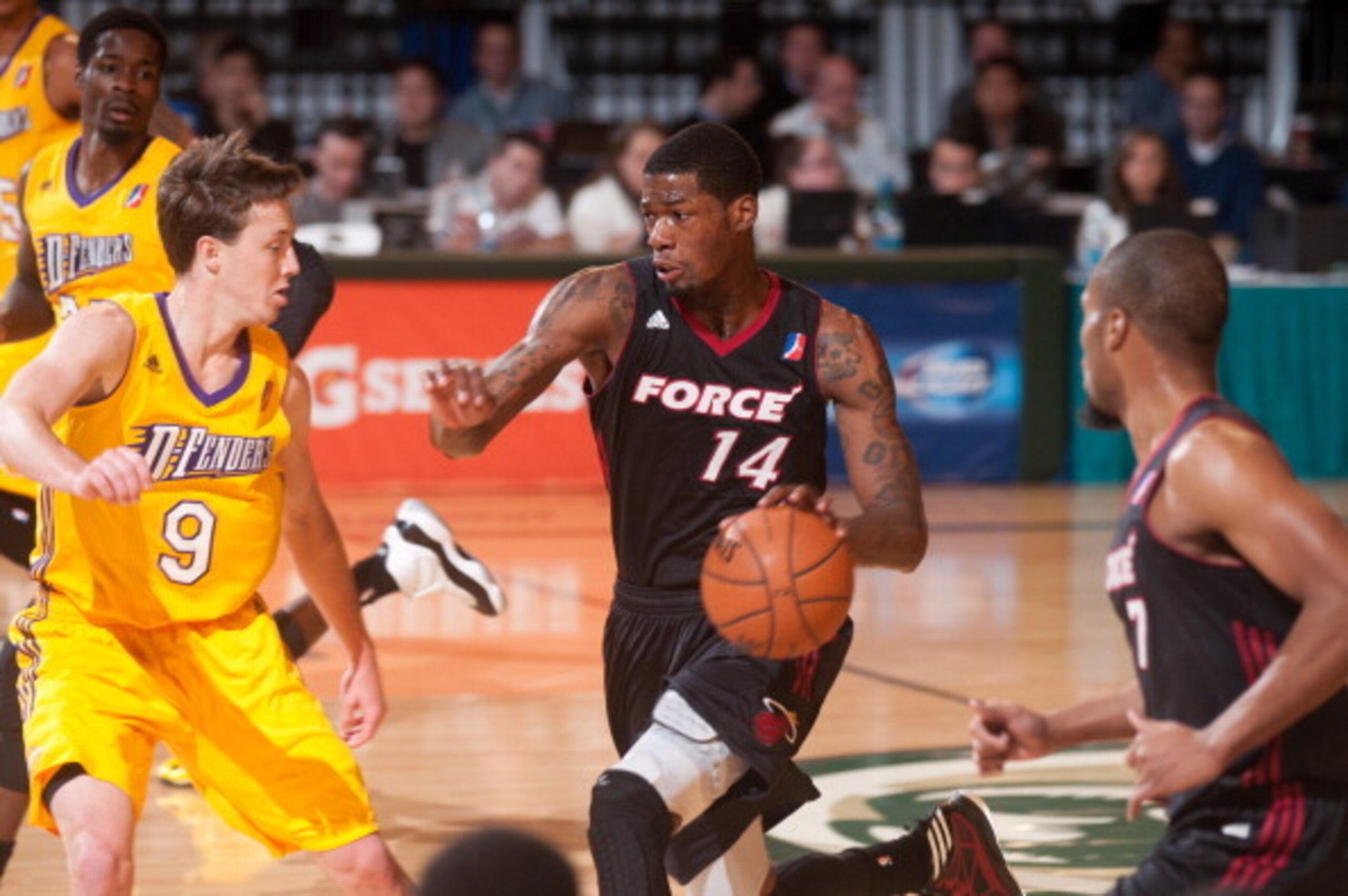 RENO, NV - JANUARY 6:  DeAndre Liggins #14 of the Sioux Falls Skyforce brings the ball up court against defender Josh Magette #9 of the Los Angeles D-Fenders during the 2014 NBA D-League Showcase on January 6, 2014 at the Reno Events Center in Reno, Nevad