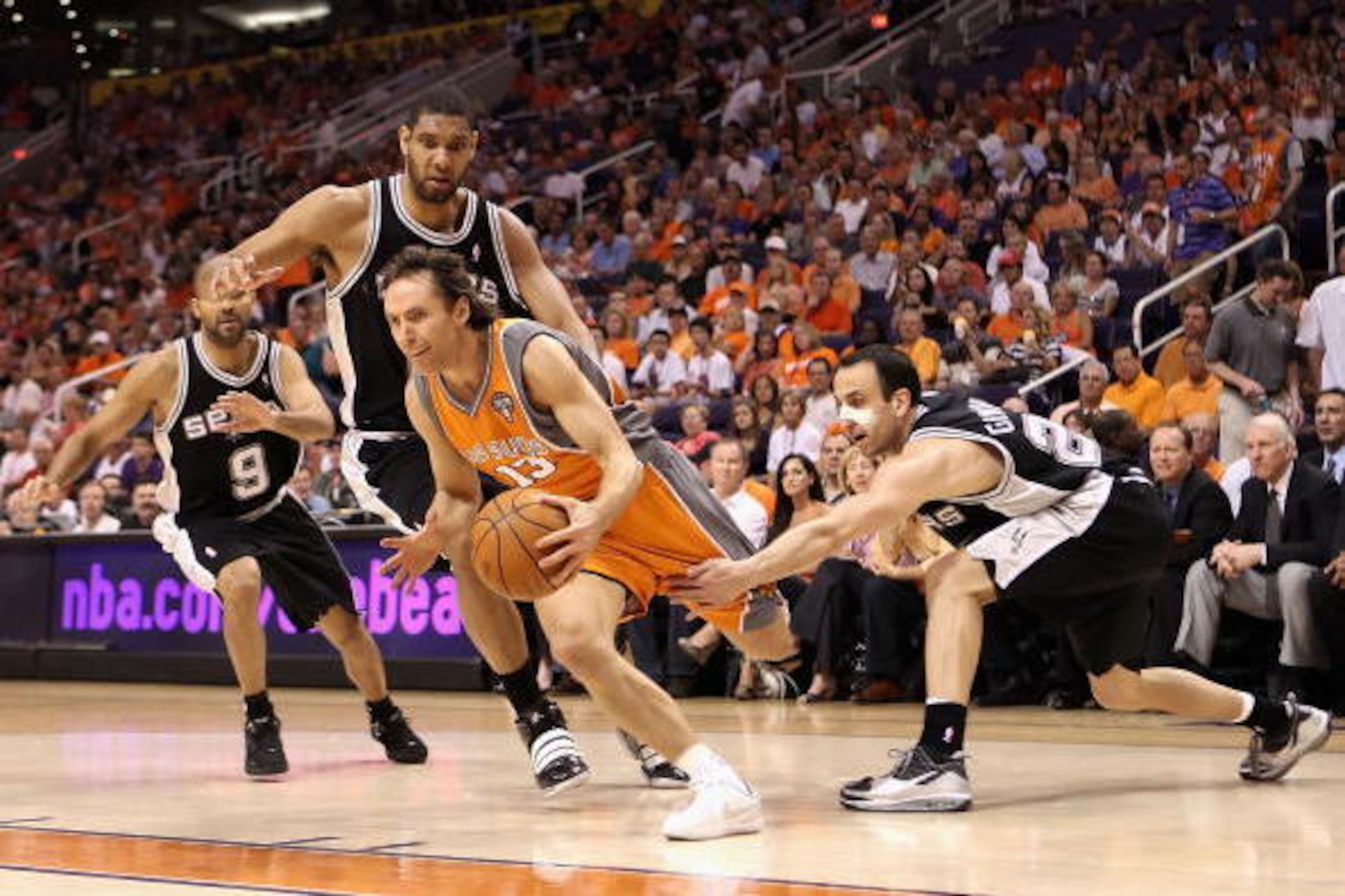 PHOENIX - MAY 05:  Steve Nash #13 of the Phoenix Suns drives the ball past Tony Parker #9, Tim Duncan #21 and Manu Ginobili #20 of the San Antonio Spurs during Game Two of the Western Conference Semifinals of the 2010 NBA Playoffs at US Airways Center on 