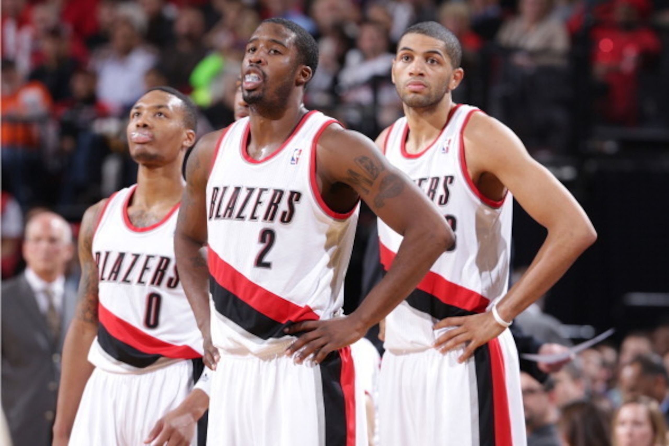 PORTLAND, OR - NOVEMBER 25:  Damian Lillard #0, Wesley Matthews #2 and Nicolas Batum #88 of the Portland Trail Blazers stand on the court against the New York Knicks on November 25, 2013 at the Moda Center Arena in Portland, Oregon. NOTE TO USER: User exp