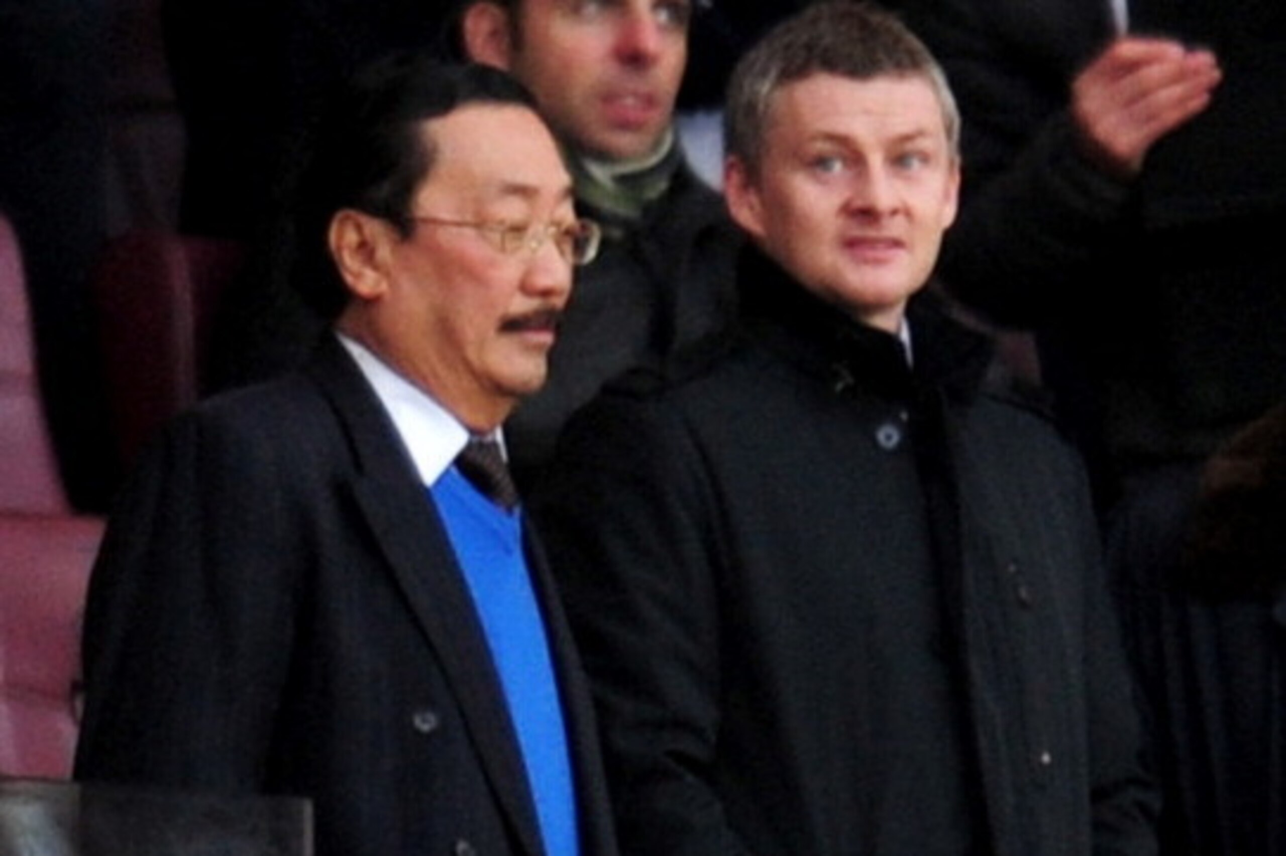 LONDON, ENGLAND - JANUARY 01:  Molde manager Ole Gunnar Solskjaer (2L) and Cardiff City owner Vincent Tan (L) look on from the stands prior to the Barclays Premier League match between Arsenal and Cardiff City at Emirates Stadium on January 1, 2014 in Lon