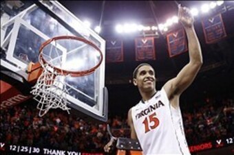 Mar 1, 2014; Charlottesville, VA, USA; Virginia Cavaliers guard Malcolm Brogdon (15) celebrates with the net after the Cavaliers game against the Syracuse Orange at John Paul Jones Arena. The Cavaliers won 75-56 and clinched the ACC regular season title. 