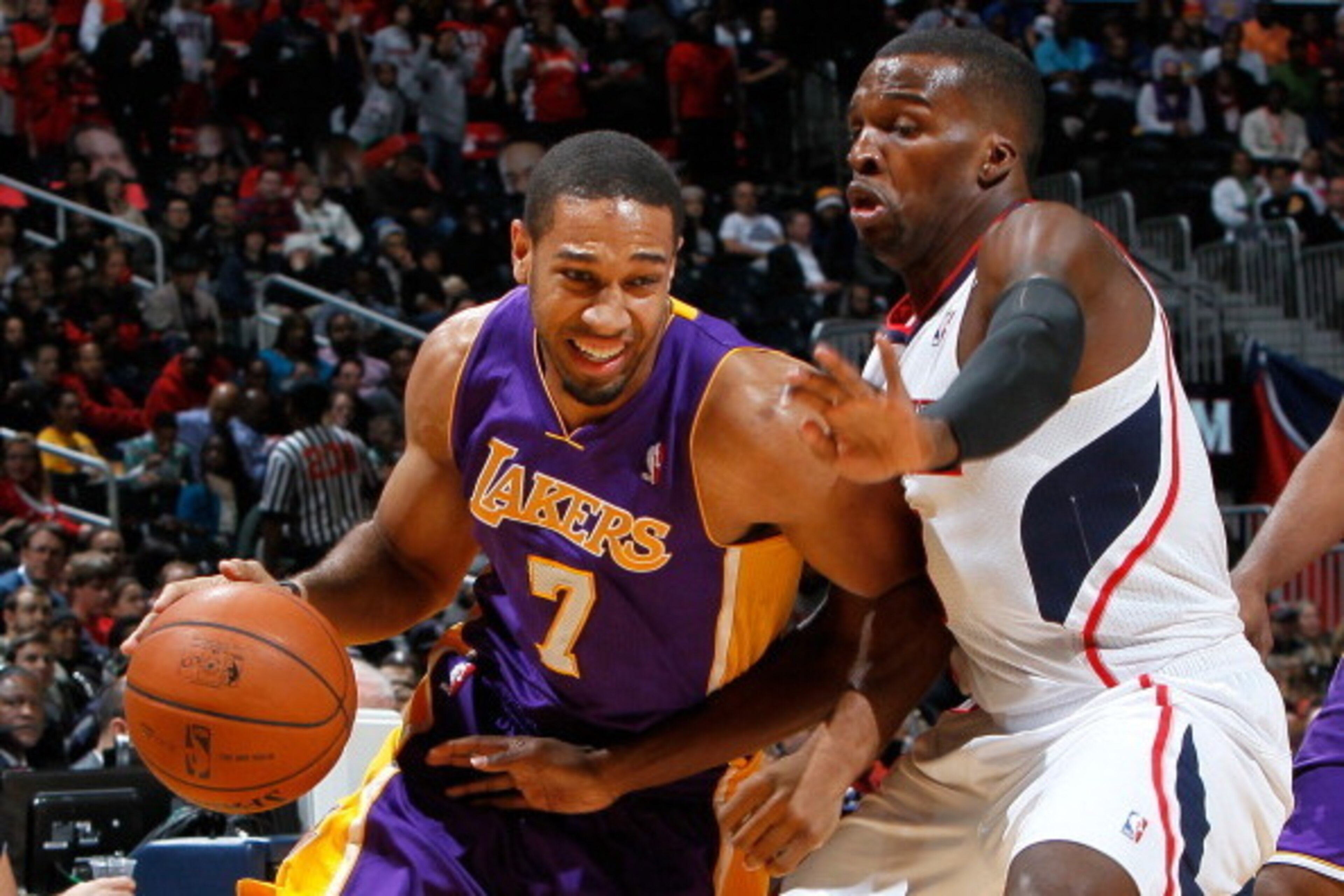 ATLANTA, GA - DECEMBER 16:  Xavier Henry #7 of the Los Angeles Lakers drives against Shelvin Mack #8 of the Atlanta Hawks at Philips Arena on December 16, 2013 in Atlanta, Georgia.  NOTE TO USER: User expressly acknowledges and agrees that, by downloading