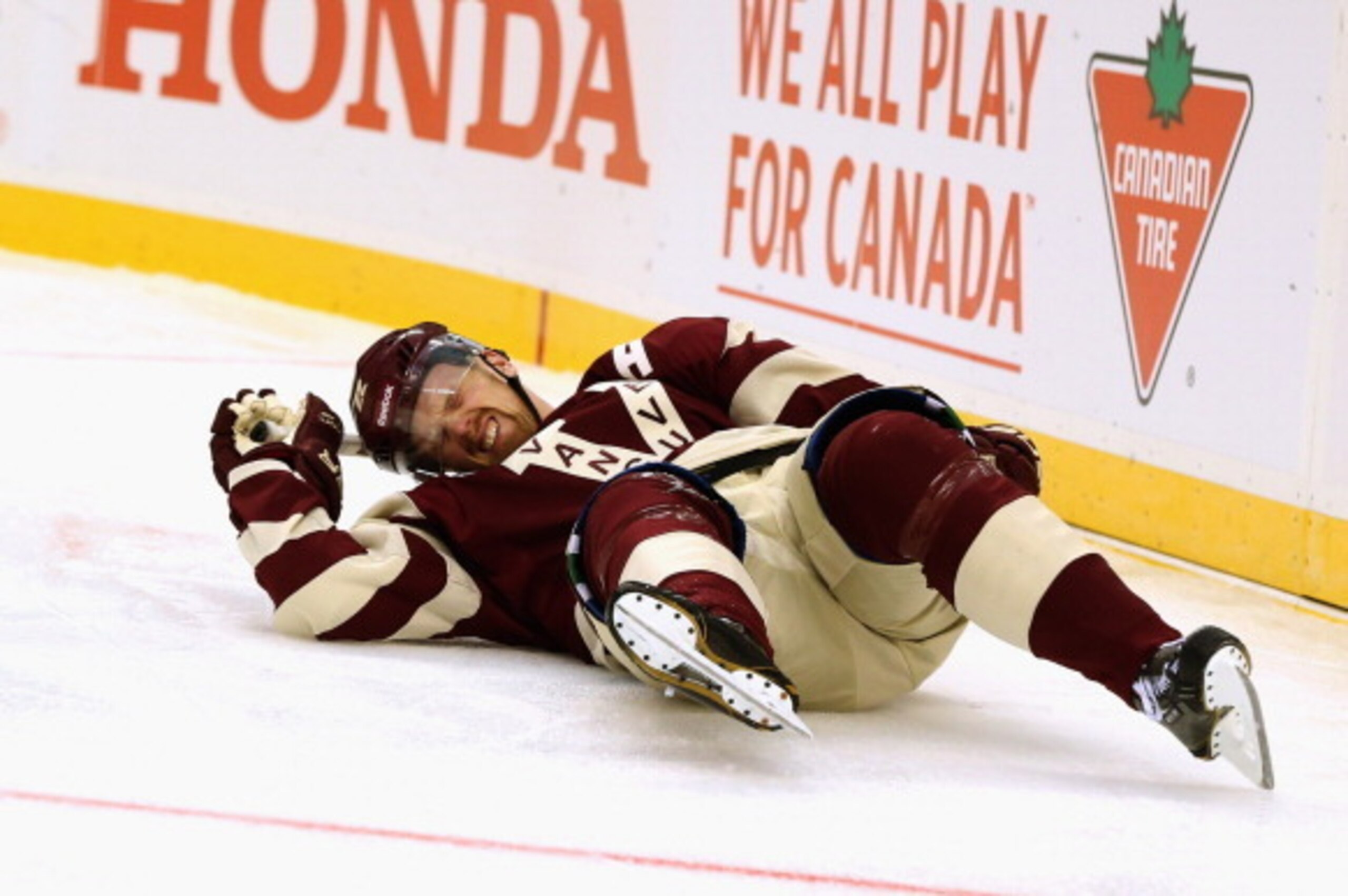 VANCOUVER, BC - MARCH 02:  (EDITORIAL USE ONLY) Daniel Sedin #22 of the Vancouver Canucks falls to the ice during the second period of the 2014 Tim Hortons NHL Heritage Classic game against the Vancouver Canucks at BC Place on March 2, 2014 in Vancouver, 