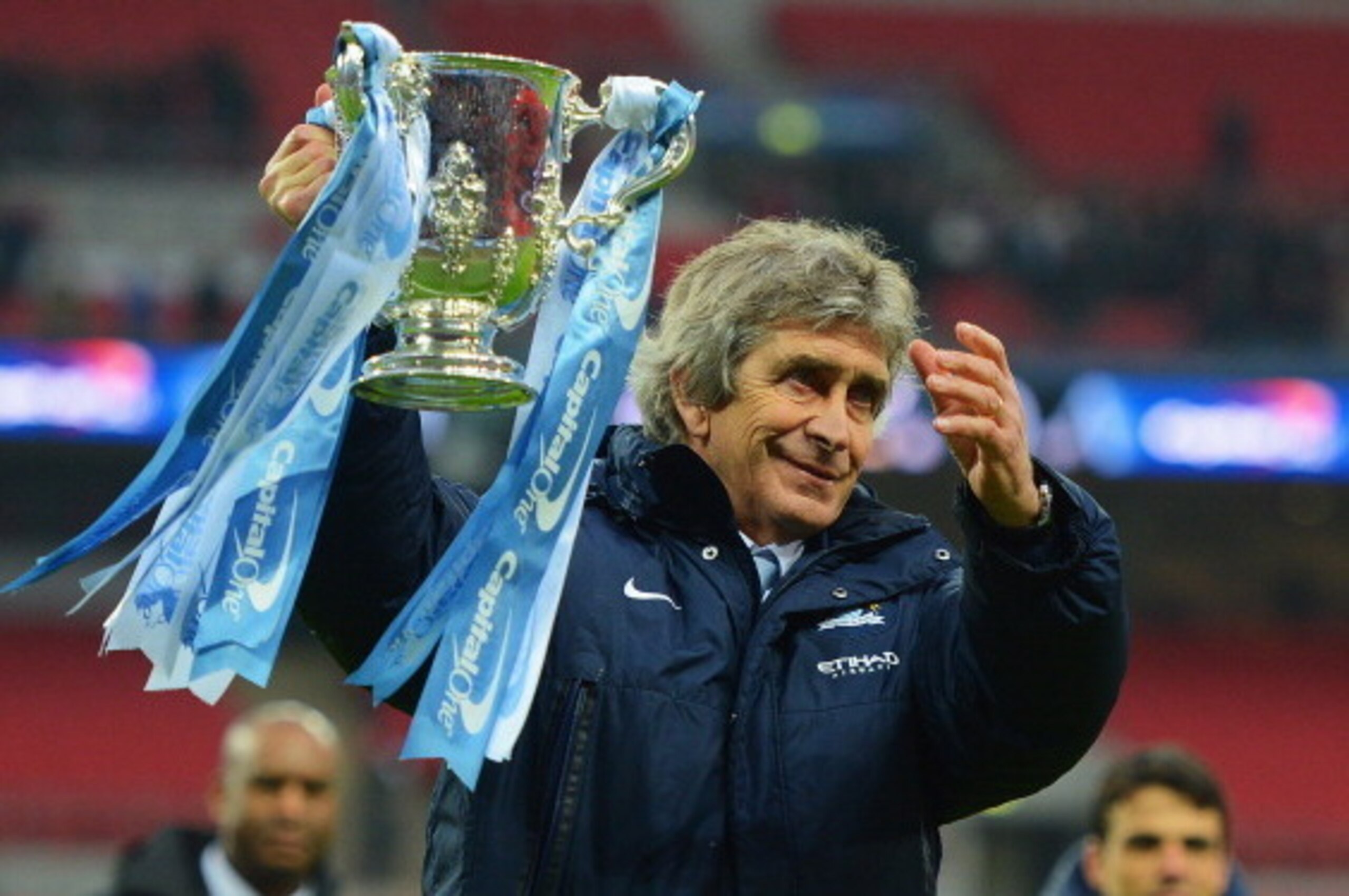 LONDON, ENGLAND - MARCH 02:  Manuel Pellegrini, manager of Manchester City celebrates victory with the trophy after the Capital One Cup Final between Manchester City and Sunderland at Wembley Stadium on March 2, 2014 in London, England.  (Photo by Michael
