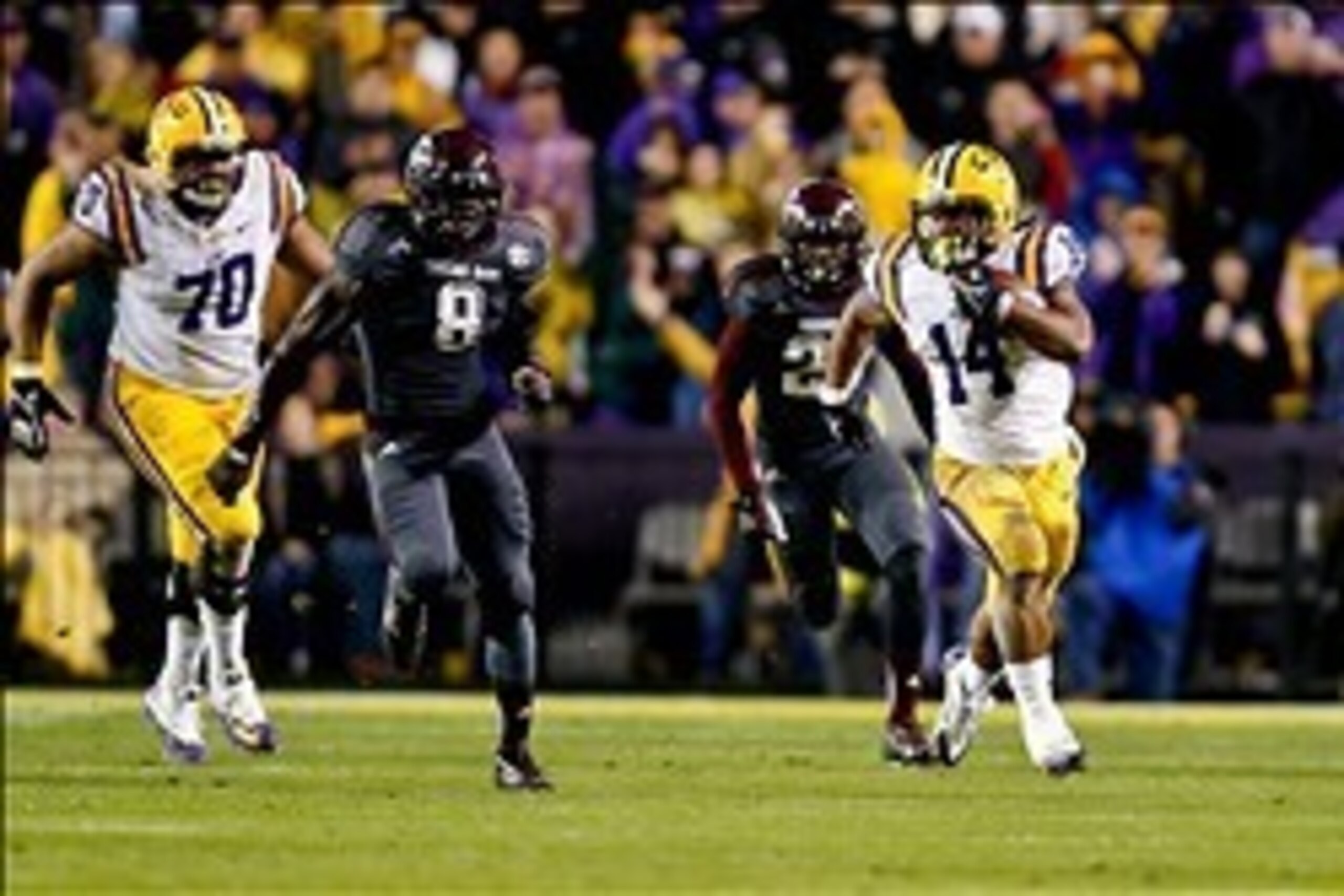 Nov 23, 2013; Baton Rouge, LA, USA; LSU Tigers running back Terrence Magee (14) runs against the Texas A&M Aggies during the second half of a game at Tiger Stadium. LSU defeated Texas A&M 34-10. Mandatory Credit: Derick E. Hingle-USA TODAY Sports