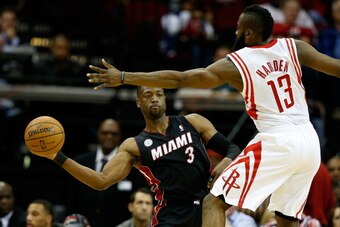 HOUSTON, TX - NOVEMBER 12:  Dwyane Wade #3 of the Miami Heat passes against James Harden #13 of the Houston Rockets at the Toyota Center on November 12, 2012 in Houston, Texas. NOTE TO USER: User expressly acknowledges and agrees that, by downloading and 