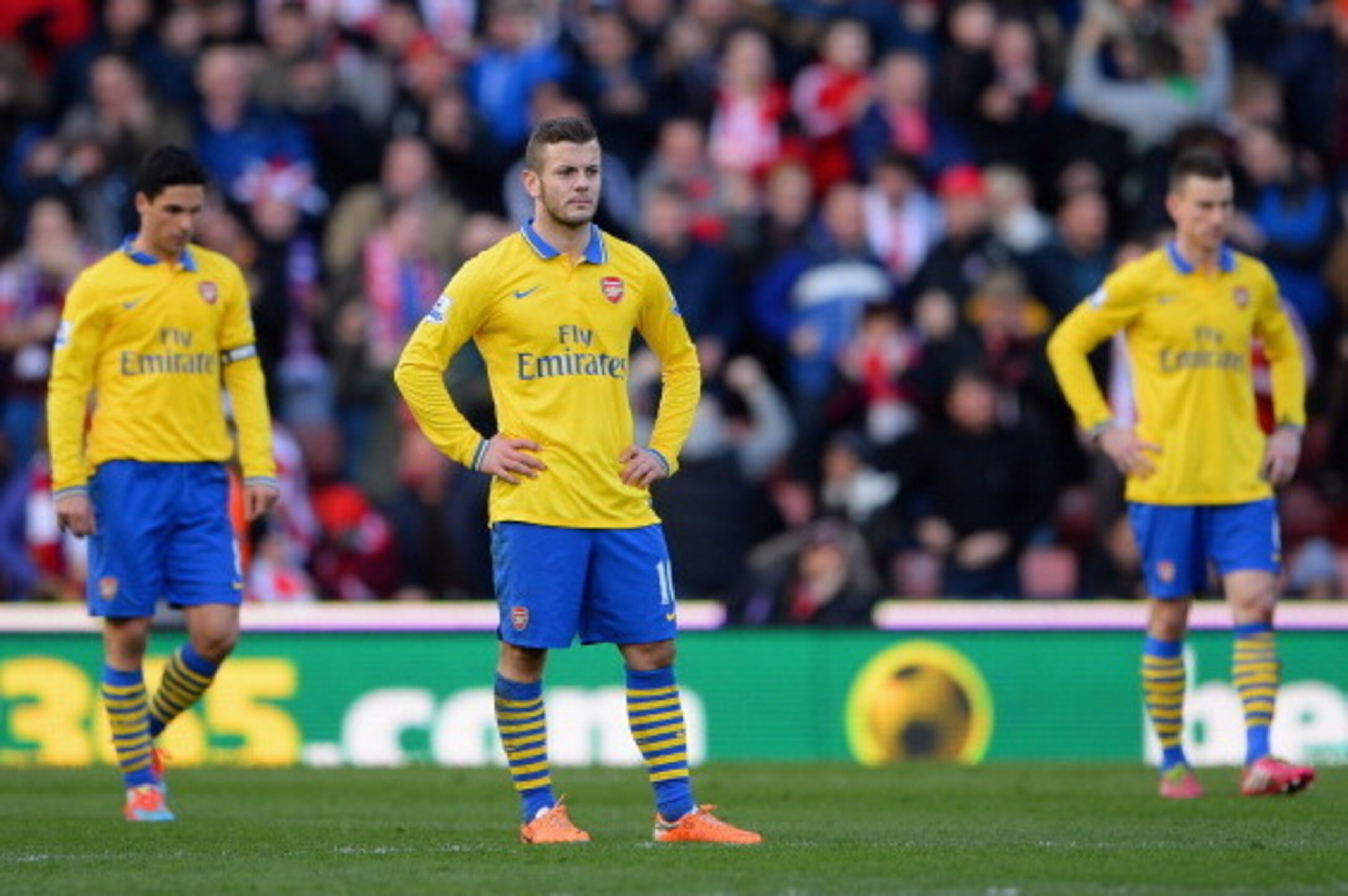 STOKE ON TRENT, ENGLAND - MARCH 01: Jack Wilshere of Arsenal and his team-mates look dejected after conceding the opening goal during the Barclays Pemier League match between Stoke City and Arsenal at the Britannia Stadium on March 1, 2014 in Stoke on Tr STOKE ON TRENT, ENGLAND - MARCH 01: Jack Wilshere of Arsenal and his team-mates look dejected after conceding the opening goal during the Barclays Pemier League match between Stoke City and Arsenal at the Britannia Stadium on March 1, 2014 in Stoke on Tr
