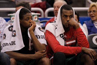 Jan 31, 2014; Orlando, FL, USA; Milwaukee Bucks point guard Brandon Knight (11) and power forward Khris Middleton (22) sit on the bench against the Orlando Magic during the second half at Amway Center. Orlando Magic won 113-102.  Mandatory Credit: Kim Kle