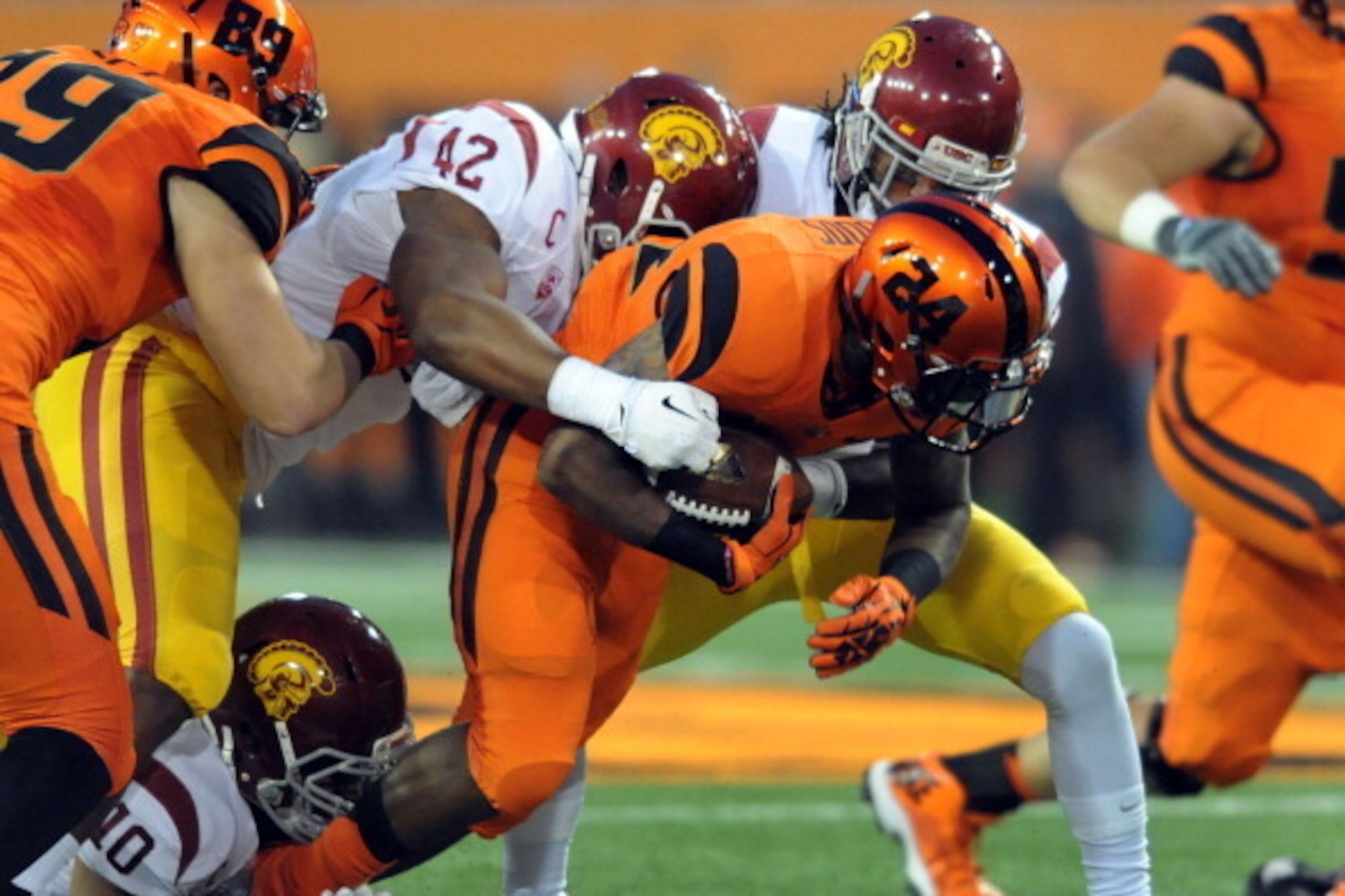 CORVALLIS, OR - NOVEMBER 01: Running back Storm Woods #24 of the Oregon State Beavers is tackled by linebacker Devon Kennard #42 of the USC Trojans during the first quarter of the game at Reser Stadium on November 1, 2013 in Corvallis, Oregon. (Photo by S