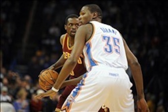 Feb 26, 2014; Oklahoma City, OK, USA; Cleveland Cavaliers small forward Luol Deng (9) handles the ball against Oklahoma City Thunder small forward Kevin Durant (35) during the first quarter at Chesapeake Energy Arena. Mandatory Credit: Mark D. Smith-USA T