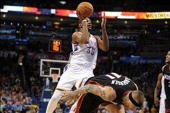 Feb 20, 2014; Oklahoma City, OK, USA; Oklahoma City Thunder small forward Kevin Durant (35) attempts a shot while being fouled by Miami Heat power forward Chris Andersen (11) during the fourth quarter at Chesapeake Energy Arena. Mandatory Credit: Mark D.