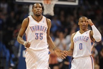 Feb 20, 2014; Oklahoma City, OK, USA; Oklahoma City Thunder point guard Russell Westbrook (0) congratulates Oklahoma City Thunder small forward Kevin Durant (35) after a made shot against the Miami Heat during the second quarter at Chesapeake Energy Arena