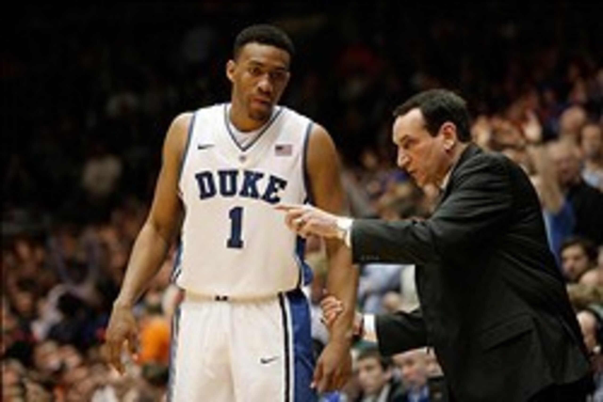 Feb 22, 2014; Durham, NC, USA; Duke Blue Devils head coach Mike Krzyzewski talks to forward Jabari Parker (1) on the sidelines against the Syracuse Orange at Cameron Indoor Stadium. Mandatory Credit: Mark Dolejs-USA TODAY Sports