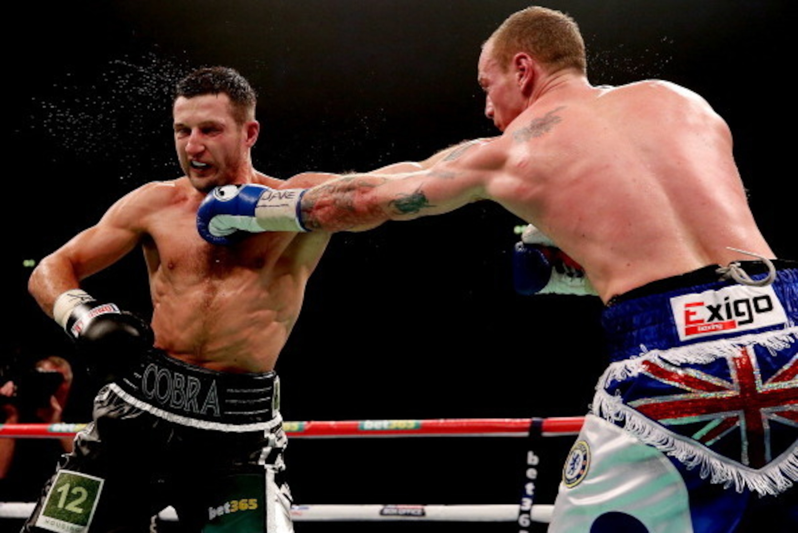 MANCHESTER, ENGLAND - NOVEMBER 23:  Carl Froch (L) in action with George Groves during their IBF and WBA World Super Middleweight bout at Phones4u Arena on November 23, 2013 in Manchester, England.  (Photo by Scott Heavey/Getty Images)