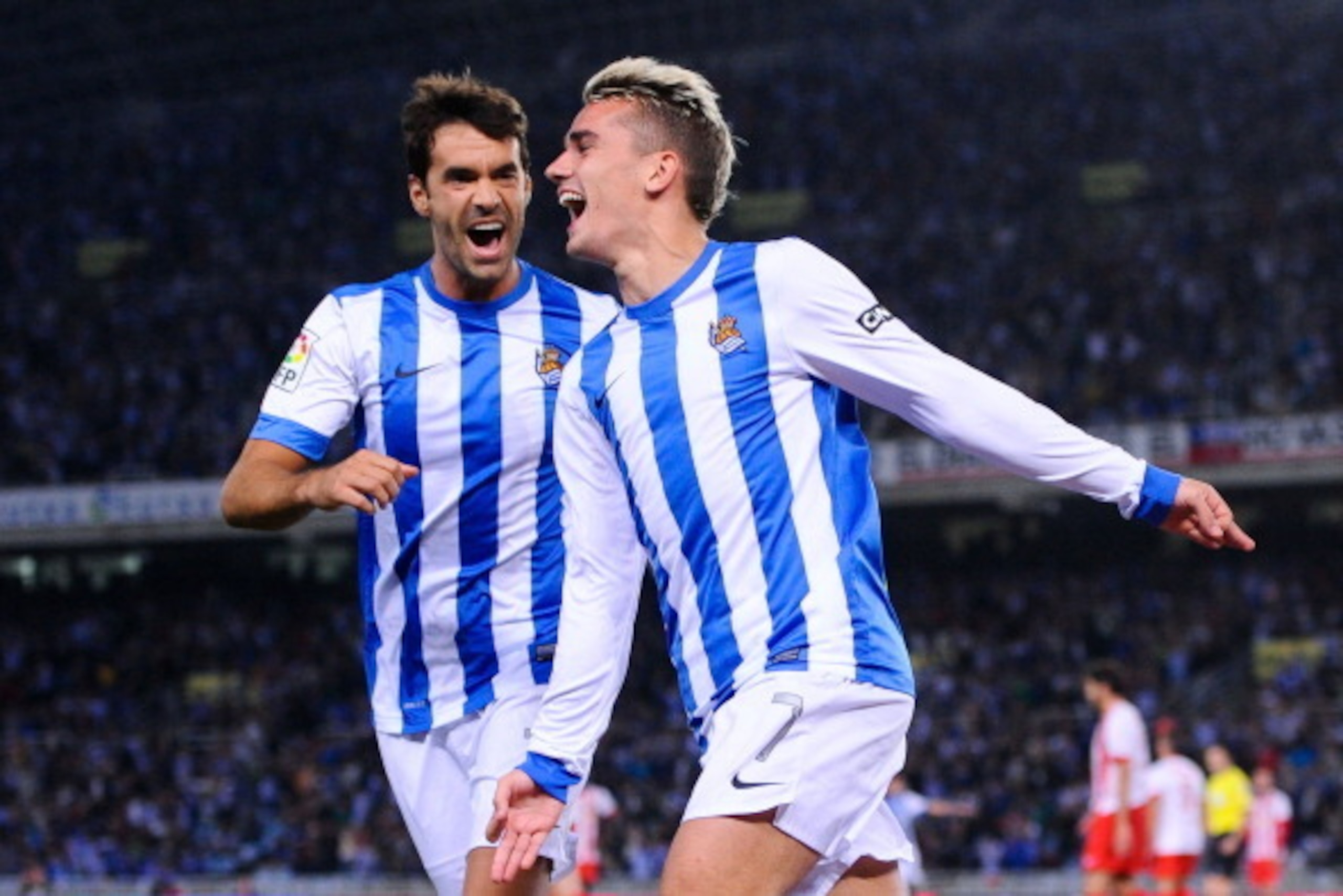 SAN SEBASTIAN, SPAIN - OCTOBER 27:  Antoine Griezmann (R) of Real Sociedad de Futbol celebrates with his teammate Xabier Prieto Argarate after scoring his team's second goalduring the La Liga match between Real Sociedad de Futbol and UD Almeria at Estadio