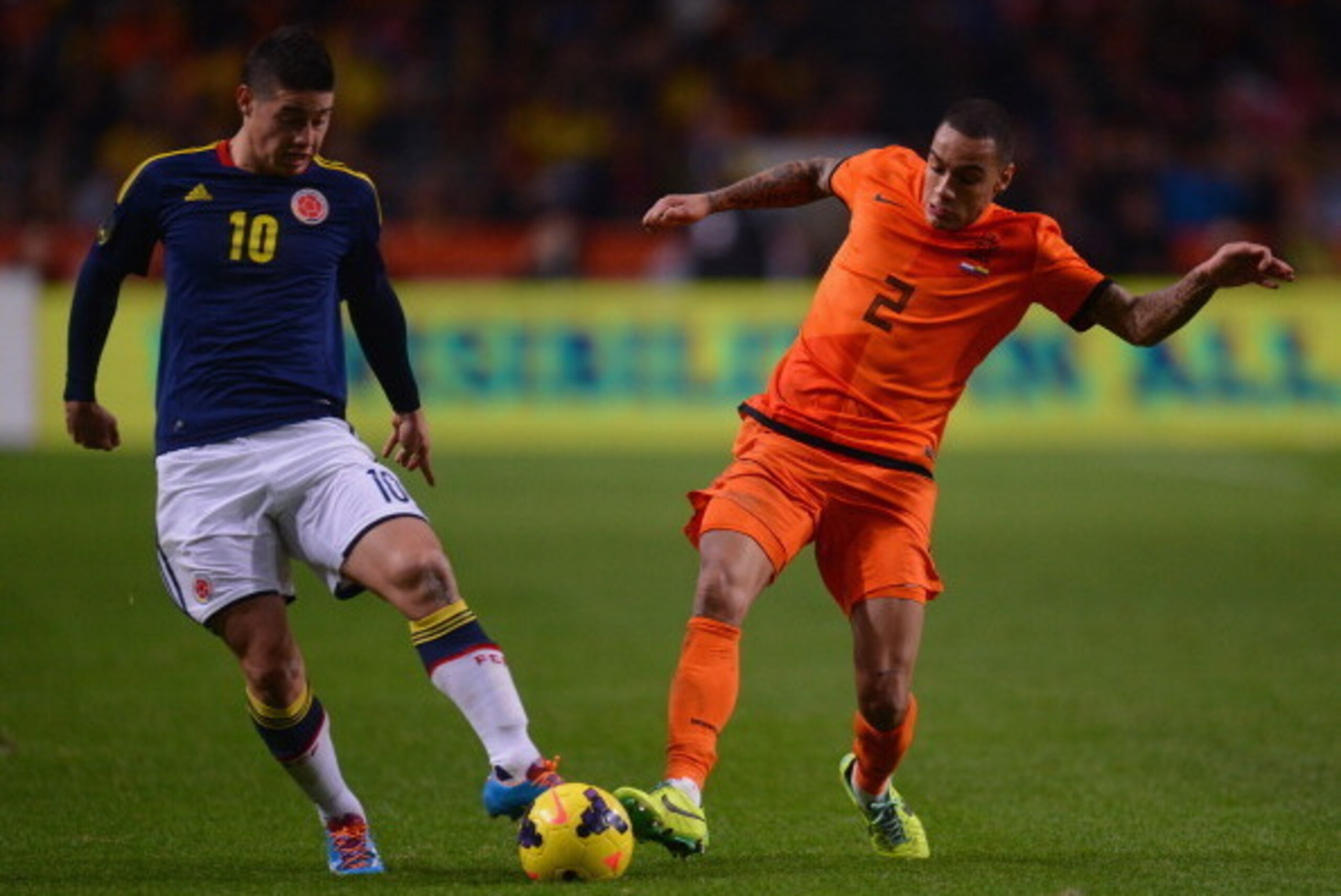 AMSTERDAM, NETHERLANDS - NOVEMBER 19:  James Rodriguez of Colombia is challenged by Gregory van der Wiel of Netherlands during the International Friendly match between Netherlands and Colombia at Amsterdam ArenA on November 19, 2013 in Amsterdam, Netherla