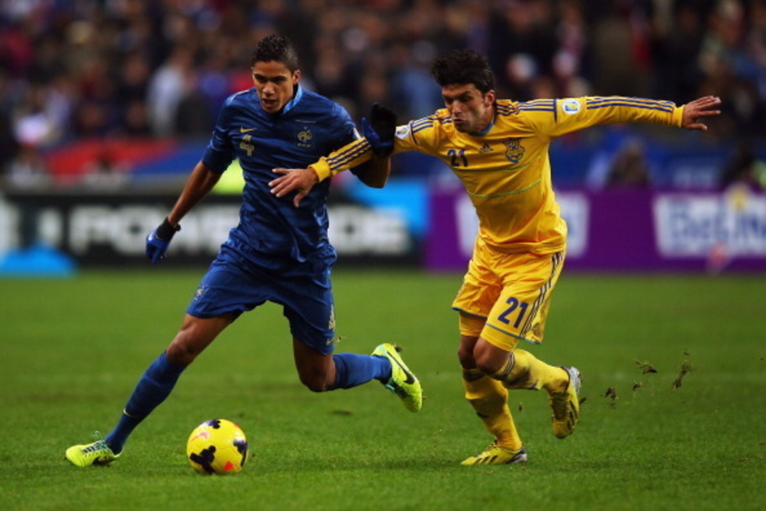 PARIS, FRANCE - NOVEMBER 19:  Raphael Varane of France battles with Edmar De Lacerda of the Ukraine during the FIFA 2014 World Cup Qualifier Play-off second leg match between France and Ukraine at the Stade de France on November 19, 2013 in Paris, France.