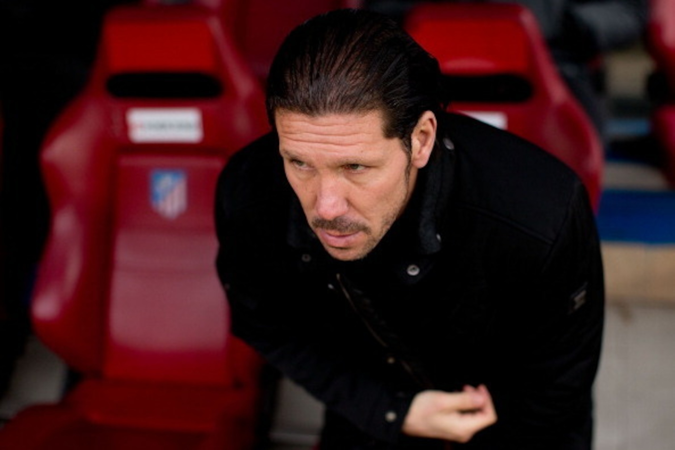 MADRID, SPAIN - FEBRUARY 15: Head coach Diego Pablo Simeone of Atletico de Madrid sits on the bench prior to start the La Liga match between Club Atletico de Madrid and Real Valladolid CF  at Vicente Calderon Stadium on February 15, 2014 in Madrid, Spain.