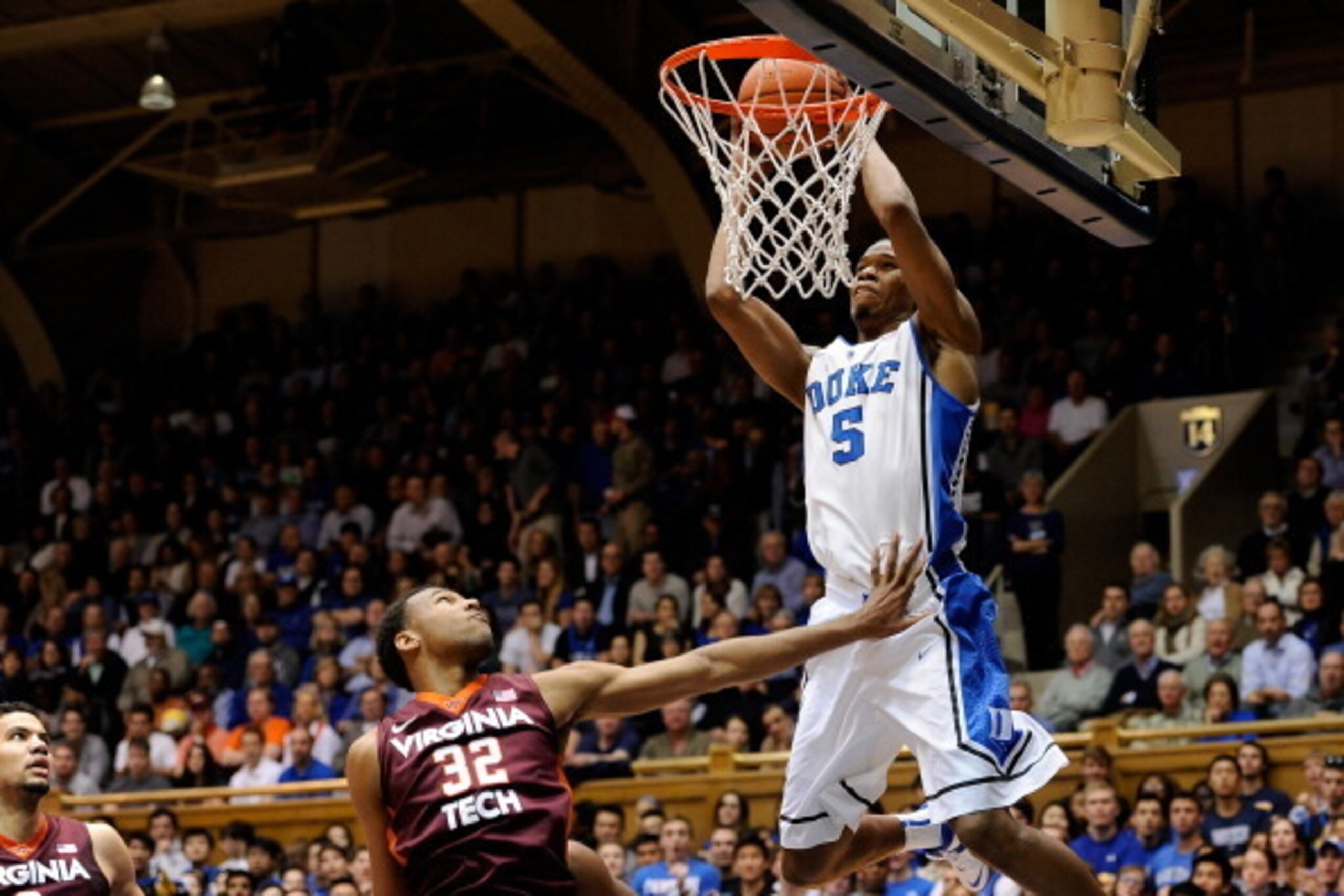 DURHAM, NC - FEBRUARY 25:  Rodney Hood #5 of the Duke Blue Devils throws down an alley-oop dunk over Trevor Thompson #32 of the Virginia Tech Hokies during a game at Cameron Indoor Stadium on February 25, 2014 in Durham, North Carolina.  (Photo by Grant H