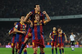 BARCELONA, SPAIN - OCTOBER 16:  Carles Puyol (C) of Barcelona celebrates scoring his team's second goal with his teammate Sergio Busquets (Top) during the La Liga match between Barcelona and Valencia at the Camp Nou stadium on October 16, 2010 in Barcelon