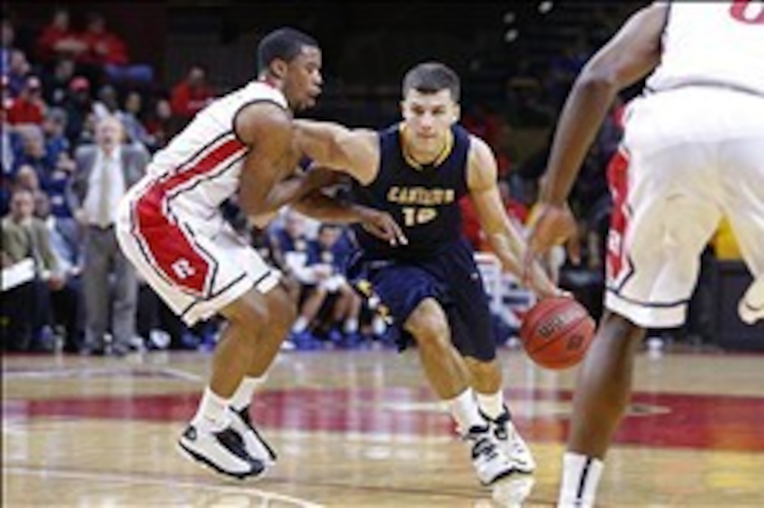 Nov 18, 2013; Piscataway, NJ, USA;  Canisius Golden Griffins guard Billy Baron (12) drives to the basket during the first half against Rutgers Scarlet Knights guard Myles Mack (4) at the Louis Brown Athletic Center. Mandatory Credit: Jim O'Connor-USA TODA