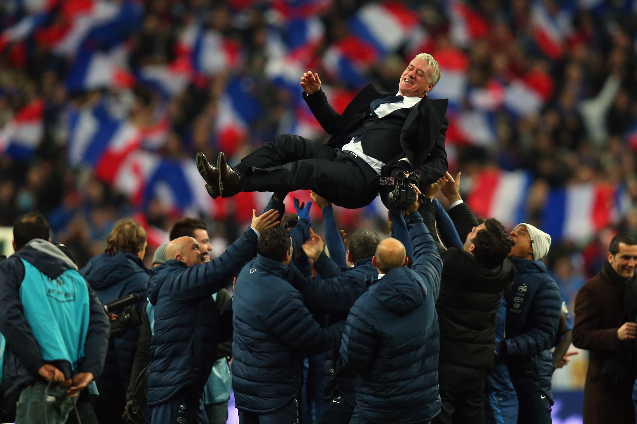 PARIS, FRANCE - NOVEMBER 19:  France throw their Coach Didier Deschamps in the air after winning the FIFA 2014 World Cup Qualifier Play-off second leg match between France and Ukraine at the Stade de France on November 19, 2013 in Paris, France.  (Photo b