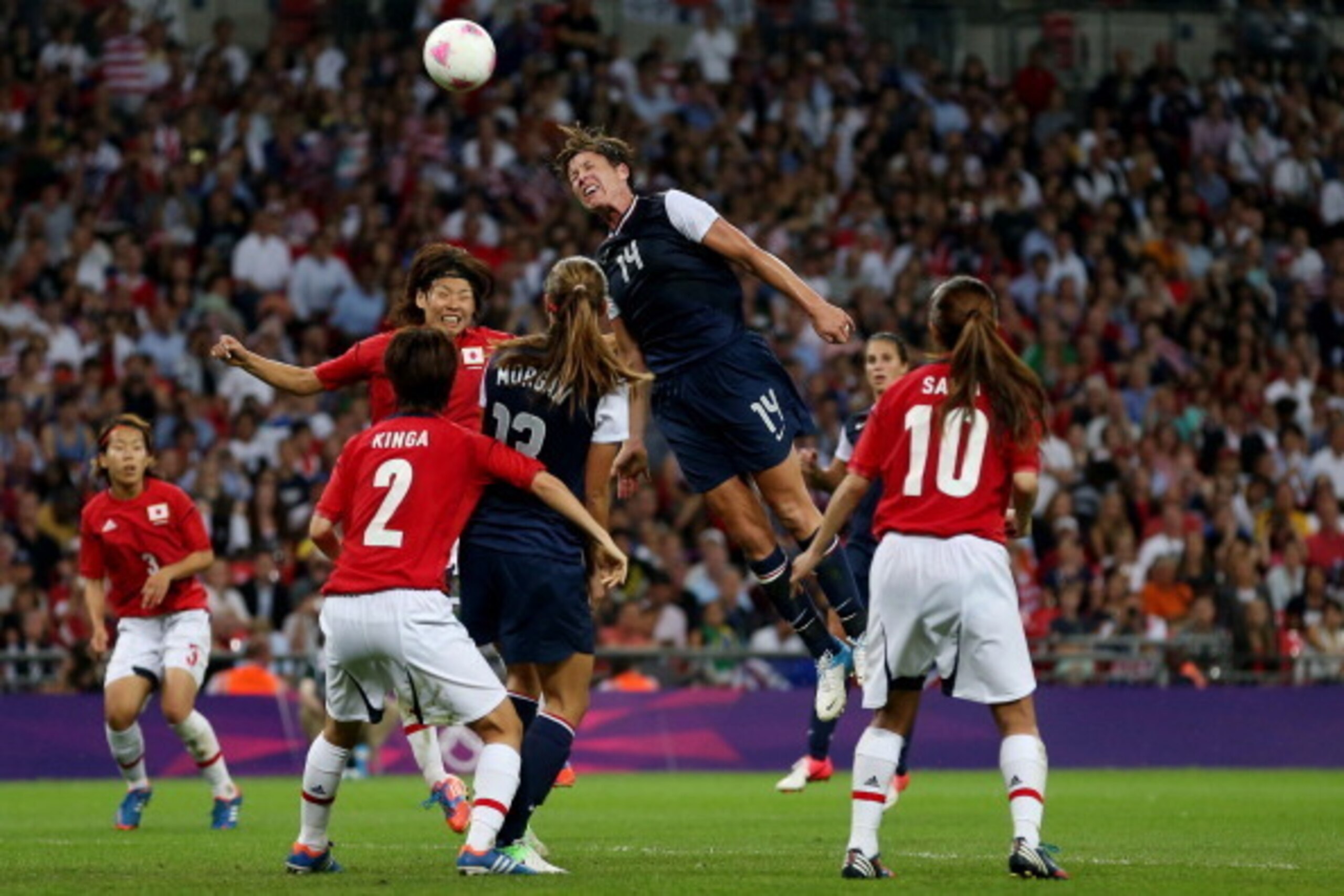LONDON, ENGLAND - AUGUST 09: Abby Wambach #14 of the United States goes up for a header against Saki Kumagai #4 of Japan during the Women's Football gold medal match on Day 13 of the London 2012 Olympic Games at Wembley Stadium on August 9, 2012 in Londo LONDON, ENGLAND - AUGUST 09: Abby Wambach #14 of the United States goes up for a header against Saki Kumagai #4 of Japan during the Women's Football gold medal match on Day 13 of the London 2012 Olympic Games at Wembley Stadium on August 9, 2012 in Londo