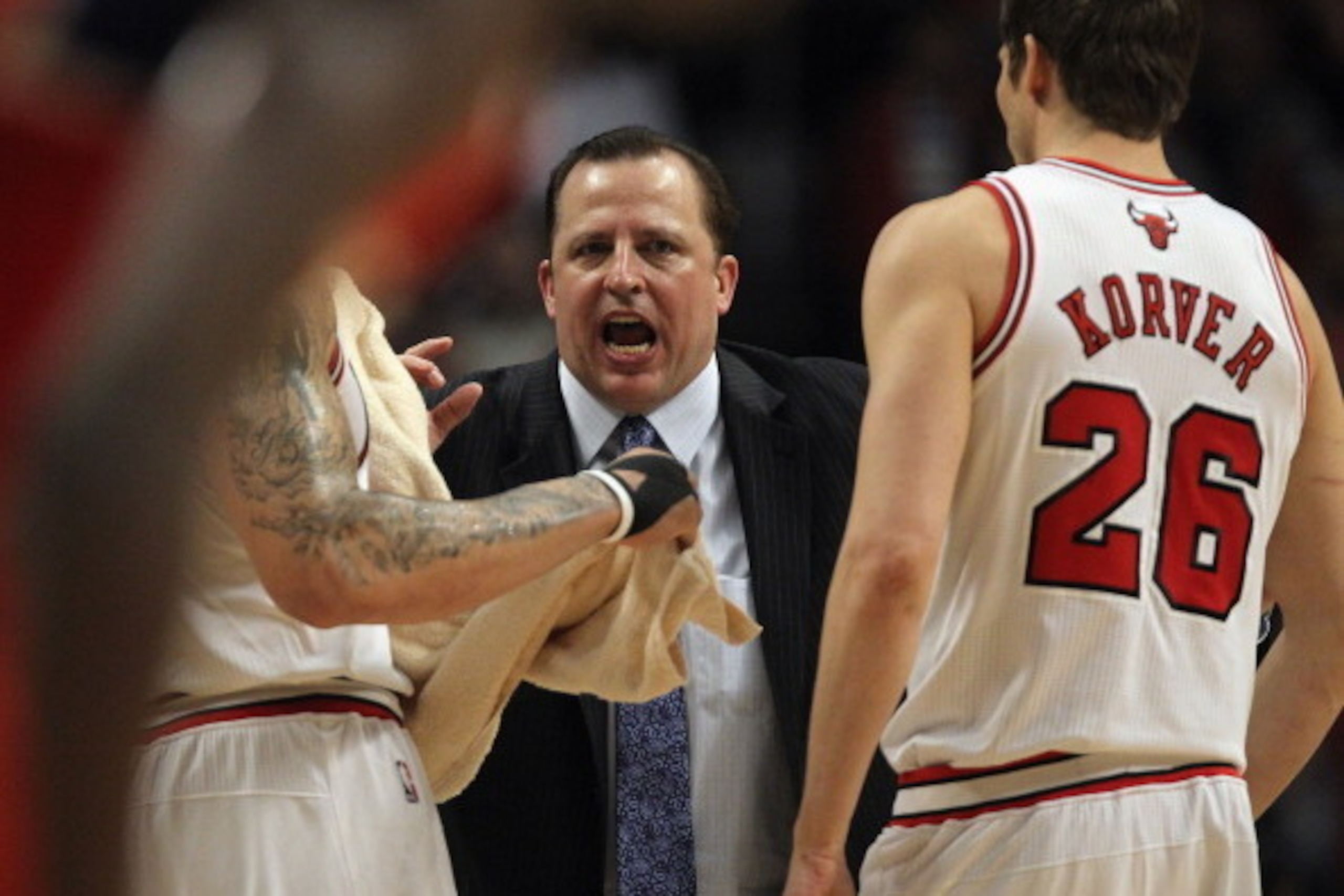 CHICAGO, IL - MAY 08: Head coach Tom Thibodeau of the Chicago Bulls gives instructions to Carlos Boozer #5 (L) and Kyle Korver #26 against the Philadelphia 76ers in Game Five of the Eastern Conference Quarterfinals during the 2012 NBA Playoffs at the Unit