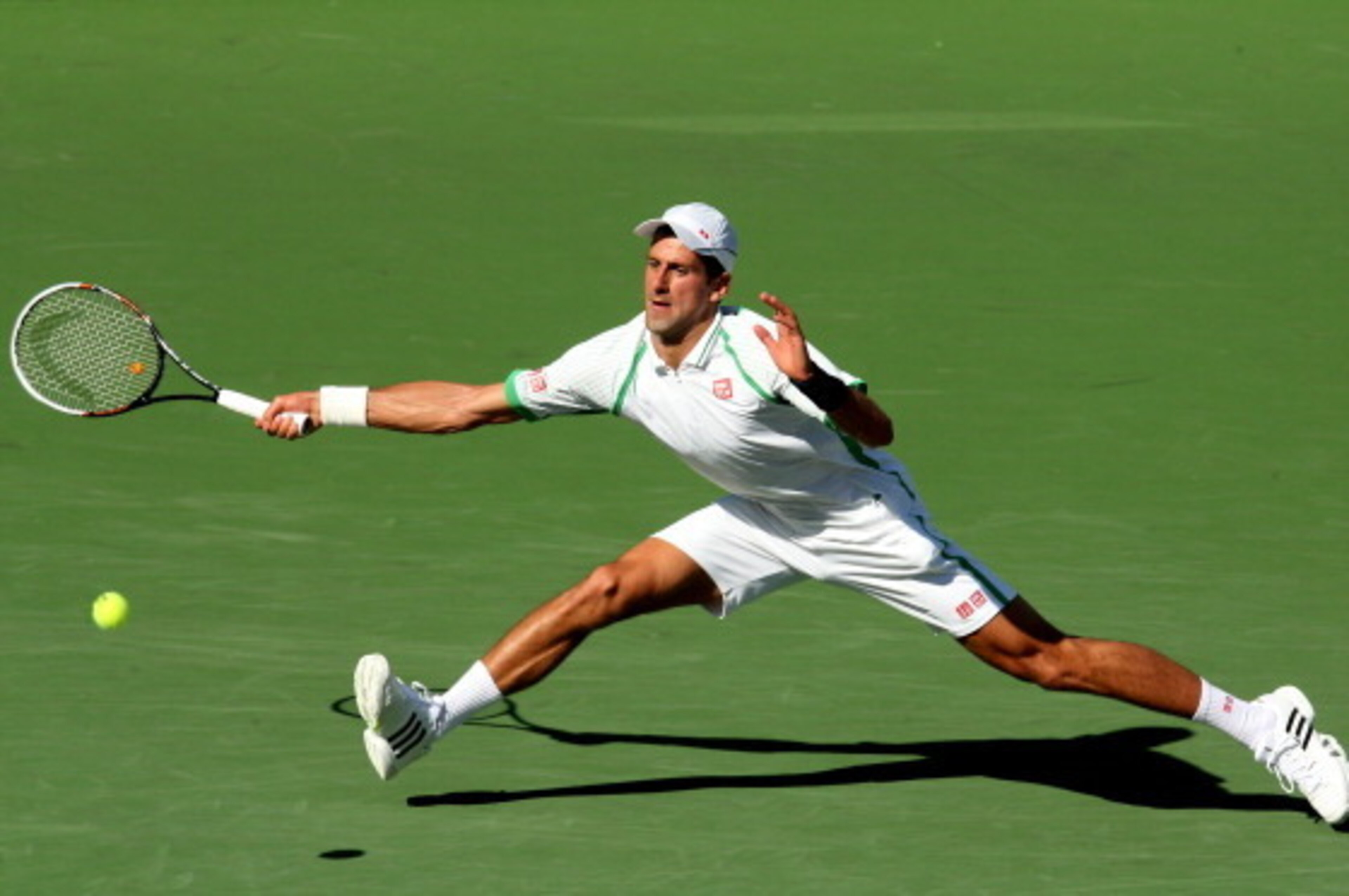 INDIAN WELLS, CA - MARCH 16:  Novak Djokovic of Serbia hits a return to Juan Martin del Potro of Argentina during the men's semifinal match of day 11 of the BNP Paribas Open at Indian Wells Tennis Garden on March 16, 2013 in Indian Wells, California.  (Ph